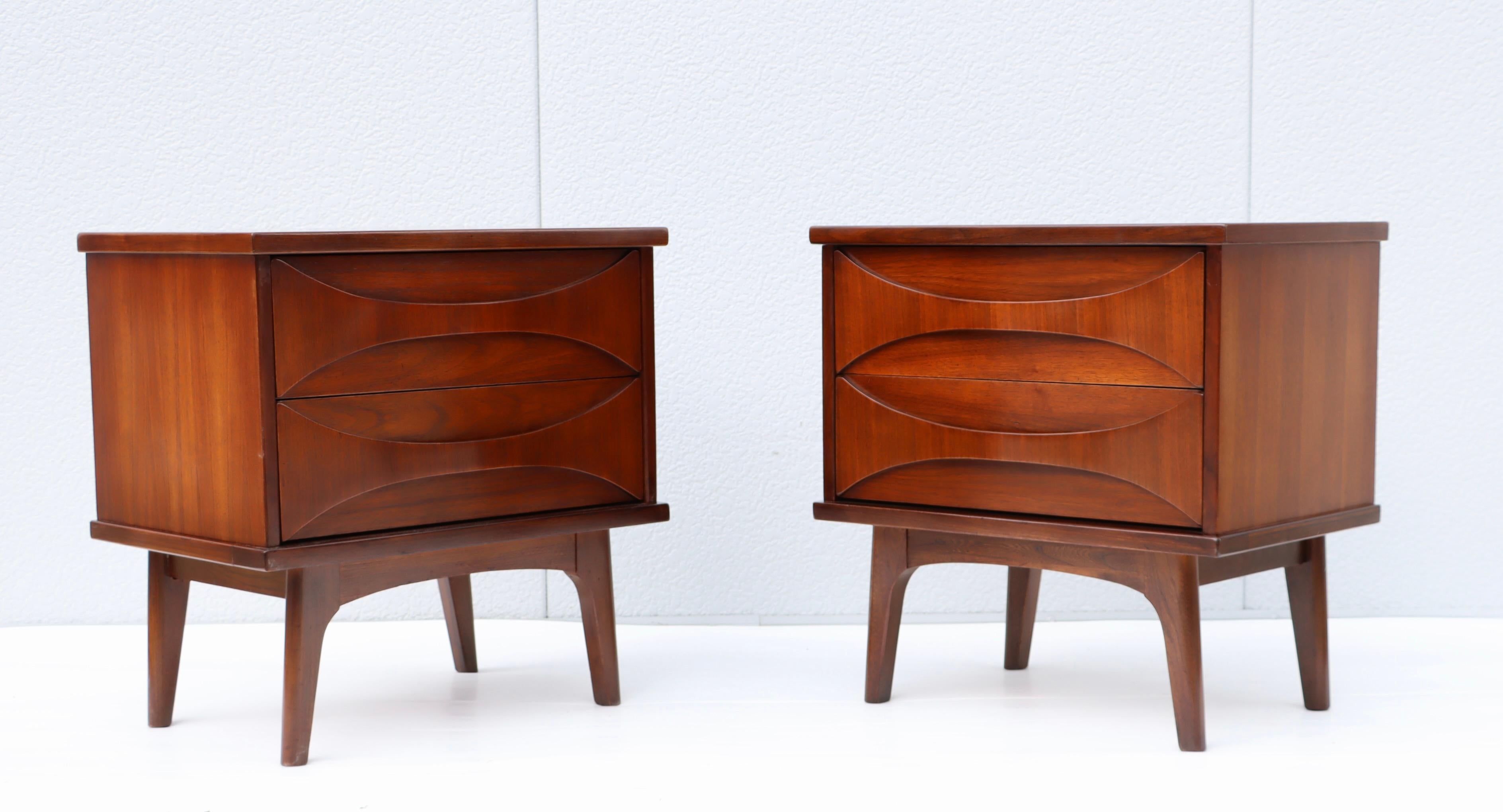 1960's modern sculptural handles walnut night stands, lightly restored with minor wear and patina due to age and use.