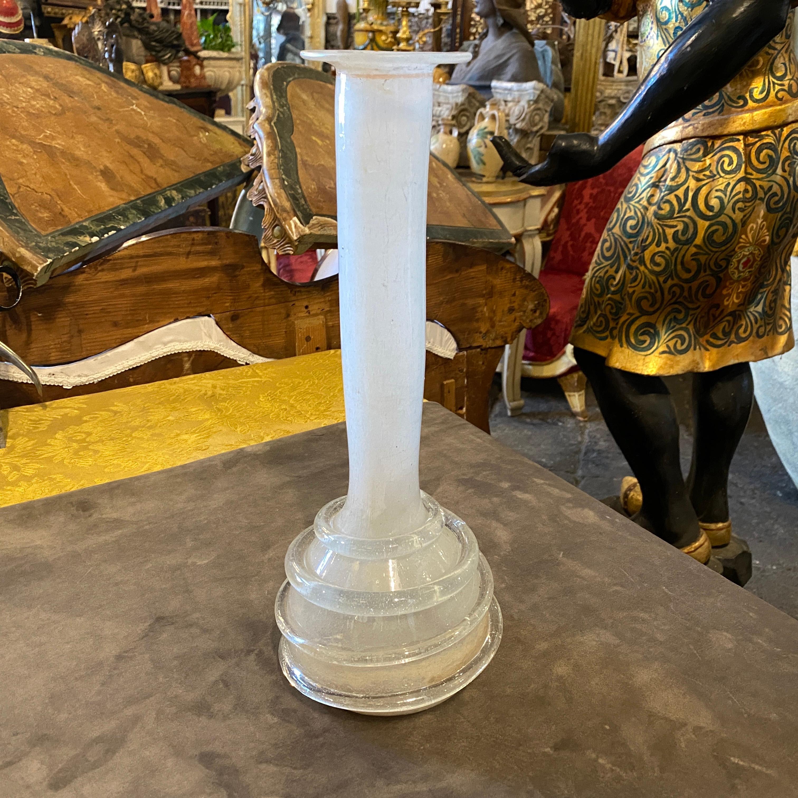 A white murano glass tall vase designed and manufactured in Venice in the Sixties in the style of Cenedese. It's in perfect conditions. the vase is a unique and elegant decorative object that captures the essence of mid-century modern design. Murano