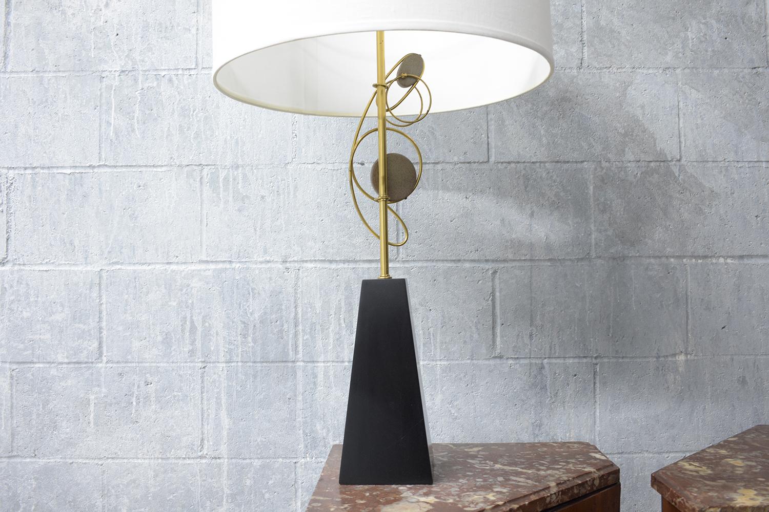 Embrace the timeless elegance of the 1960s with our extraordinary pair of mid-century modern table lamps. These lamps, in great condition, are a testament to the unique style and craftsmanship of the era. Beautifully crafted from a wood and brass