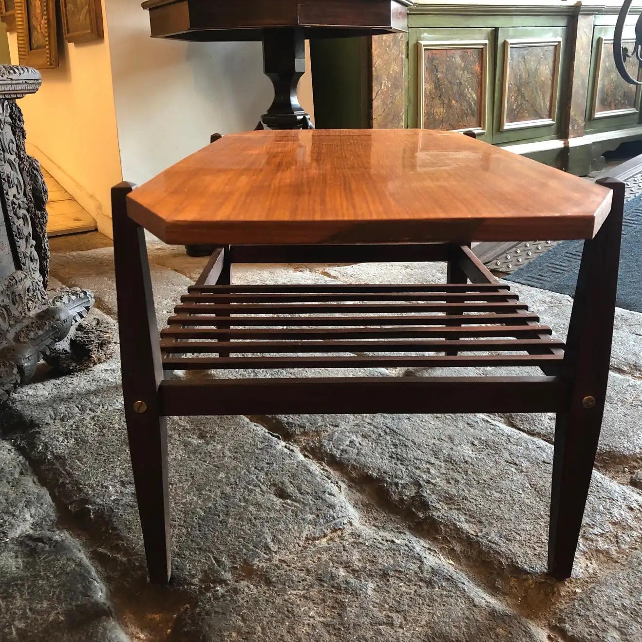 A stylish teak and mahogany coffee table made in Italy in the 1960s in very good conditions. This item it's in a lovely clean scandinavian style.
This wood octagonal Italian coffee table features clean lines, geometric shapes, and a combination of