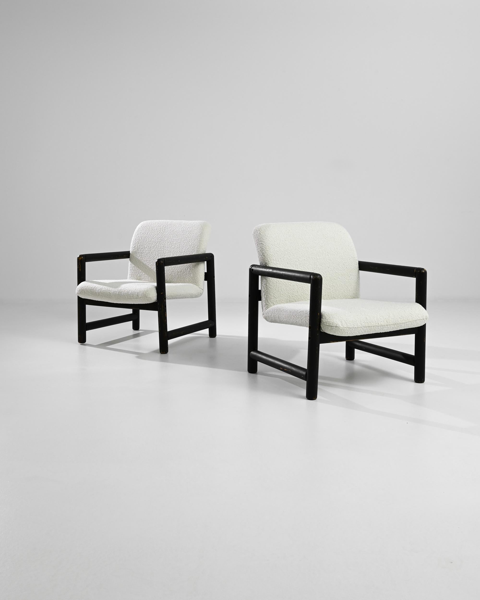 Handcrafted in 1960s Czechia by TON furniture makers, this pair of Midcentury Modernist armchairs are a find to treasure. The silhouette is stylish and clean, softened by rounded edges and soft corners. The bold black lines of the wooden frame