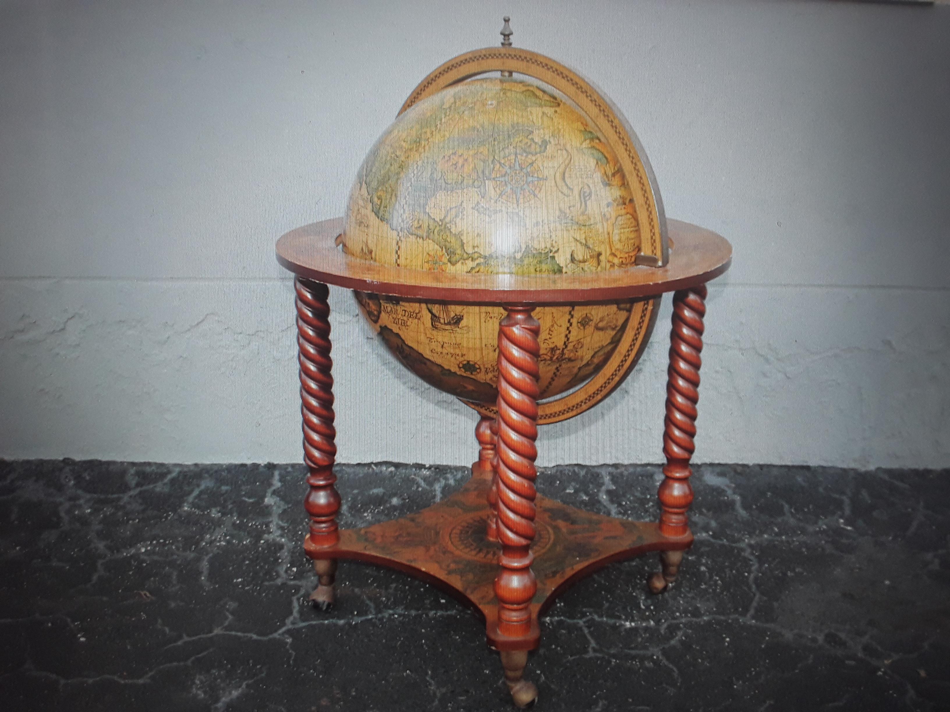 1960's Mid Century Modern World Globe Dry Bar. Top half opens to reveal bottle storage. Very nice art work. Turned wood supports.
