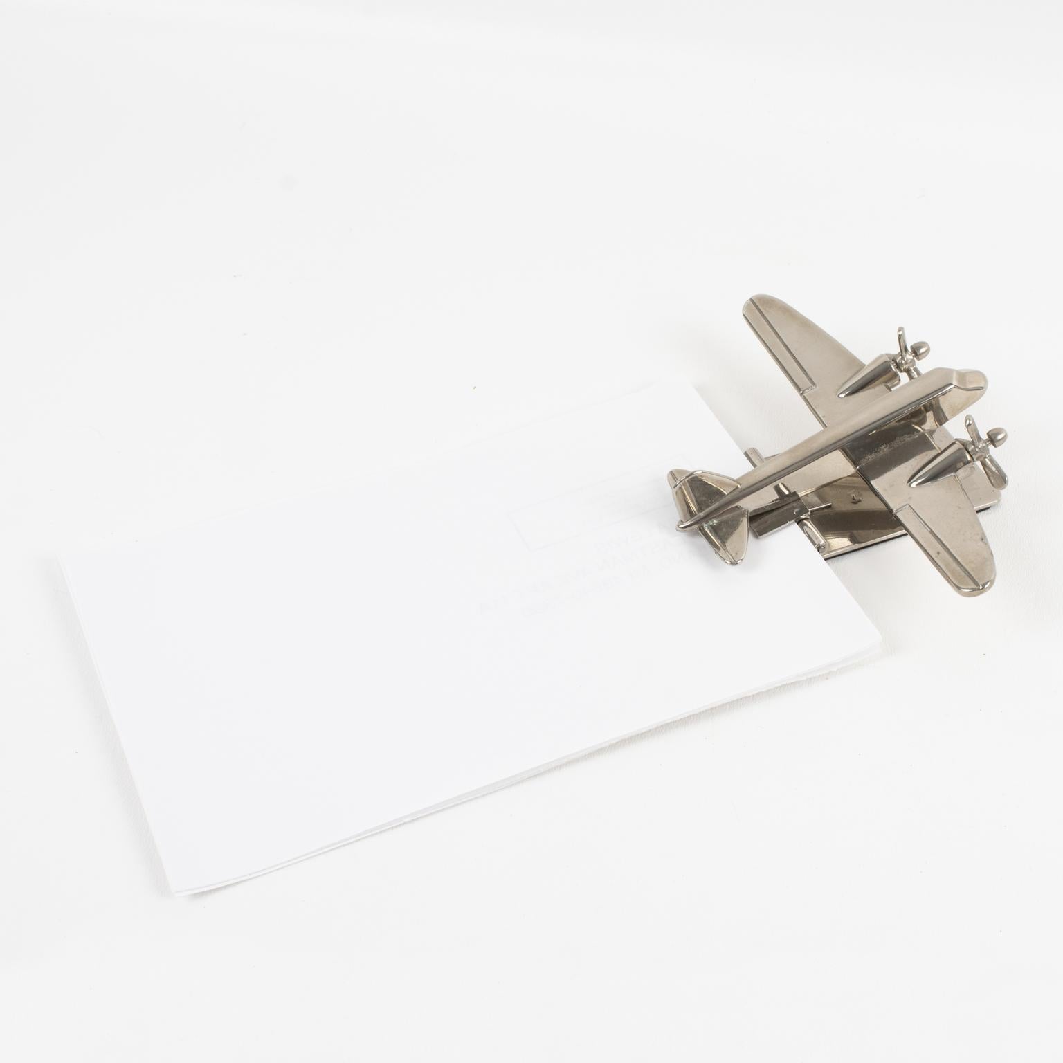 Stunning French 1960s Mid-Century airplane model desk accessory, paper clip. It is a small-scale airplane in chromed metal attached to a chrome plinth that can be used as a paper clip. Two propellers are in rotating condition. No visible maker's