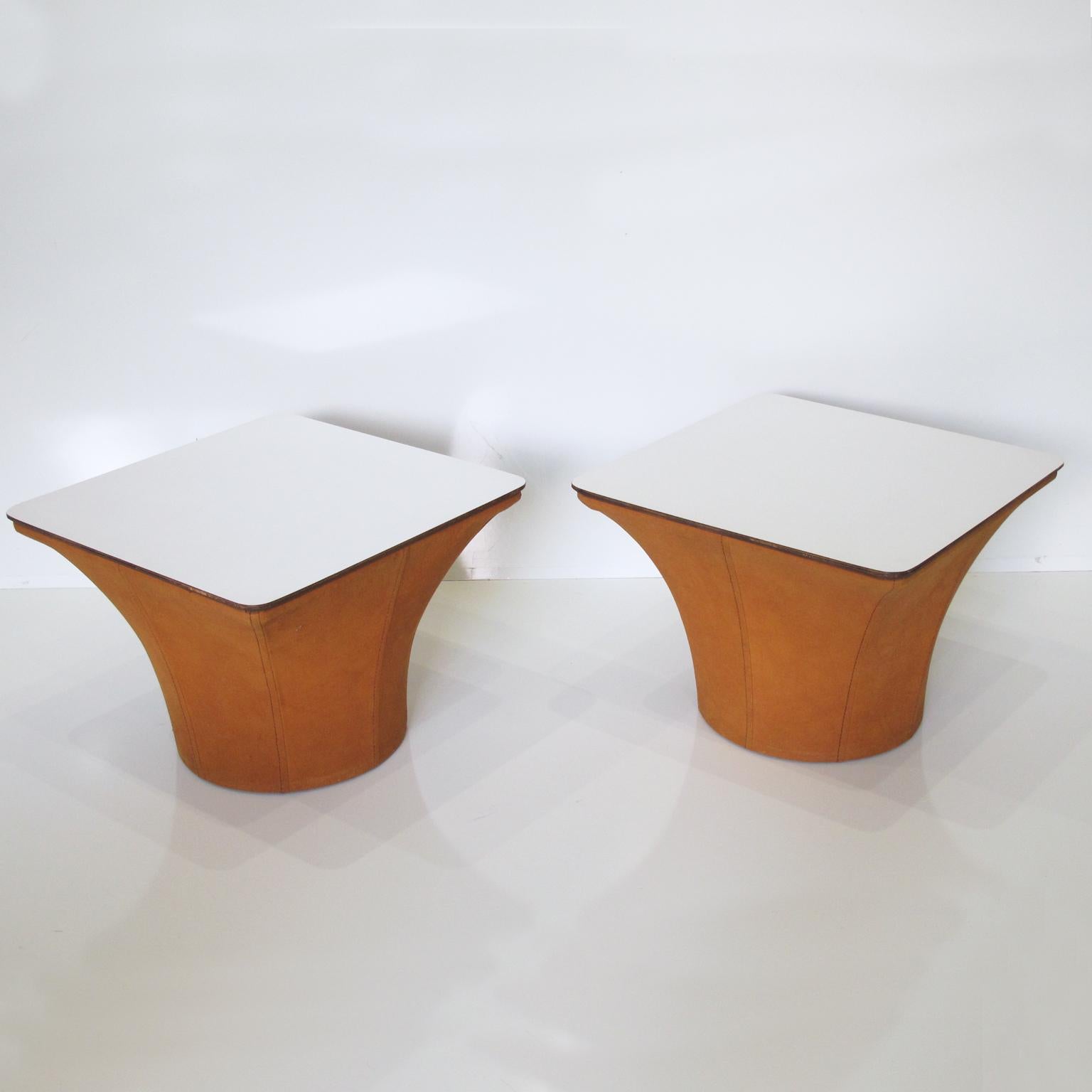 Lovely pair of Mid-Century Modern mushroom side tables. Perfect Minimalist design and shape for end sofa tables or nightstands use. Featuring original suede fabric in cognac color base and white laminate square tray tabletop.
Measures: 19.69 in.