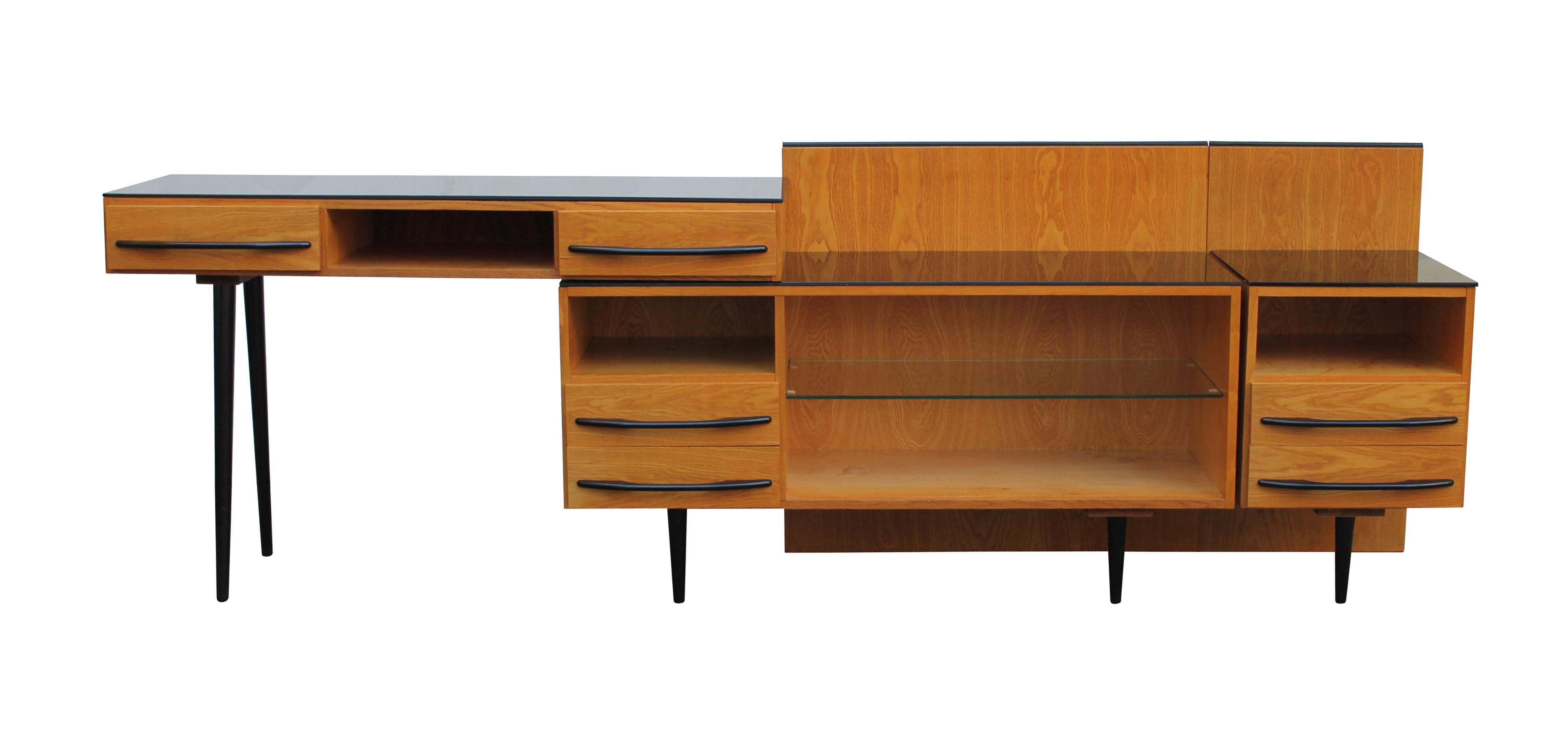 This Mid-Century Modern Modular Set was designed by Mojmir Pozar and produced by UP Zavody, Bucovice factory in 1960s Czechoslovakia.

This is a Modular set that consists of a writing desk, cabinet, side table and two headboards for the double