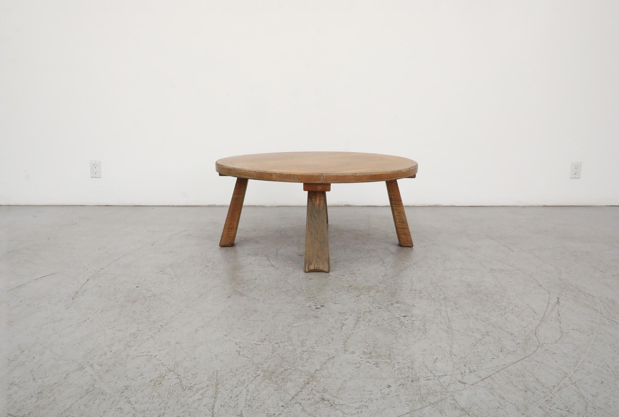 This 1960's, Brutalist Pierre Chapo inspired oak coffee or side table with a solid round top and attractively tapered splayed legs. In very original condition with heavy signs of use and wear including scratches, cracking and stains. This table is
