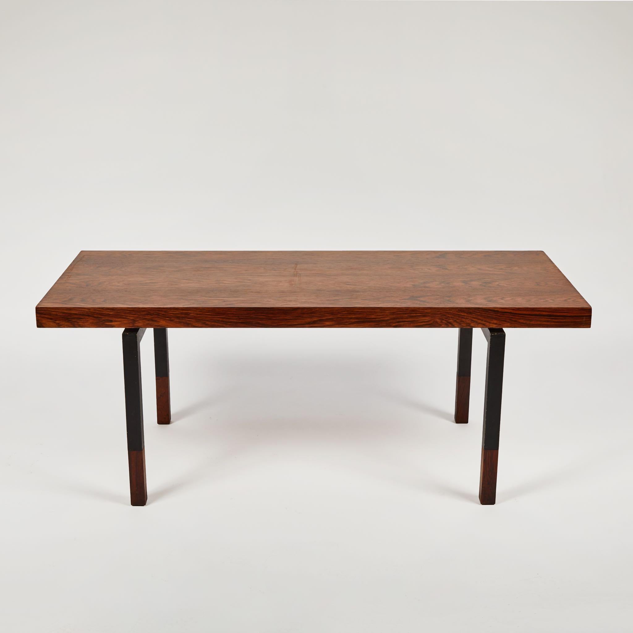 French 1960s coffee table with rectangular walnut top and slim black iron and walnut legs. A sleek and geometric mid-century modern piece with wonderful lines; the top appears almost to be floating in space. 

France, circa 1960

Dimensions: 45W x