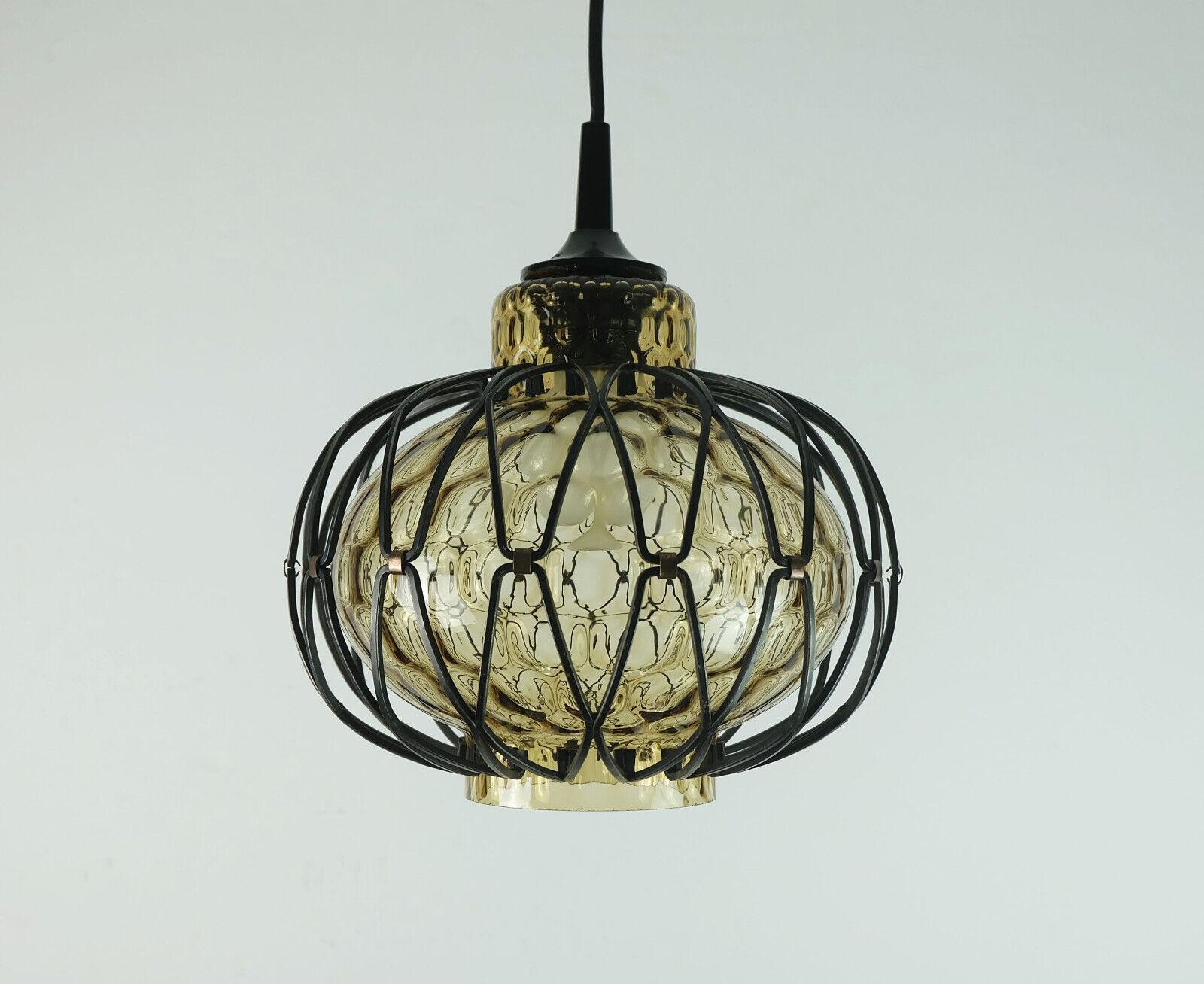 Beautiful small pendant light from the 1960s/70s. The shade is made of smoked glass with a honeycomb structure. The frame around the glass is made of black painted metal and small copper elements. Black electric wire and black canopy. Holds one E27