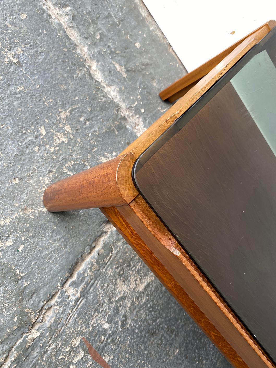 Mid century modern coffee table by respected English maker ‘Myer’. Solid countered teak frame with thick smoked glass insert

Size 
Width 112cm x depth 48cm x height 35cm

Condition:
Very good mid century condition. Minor signs of wear consistent