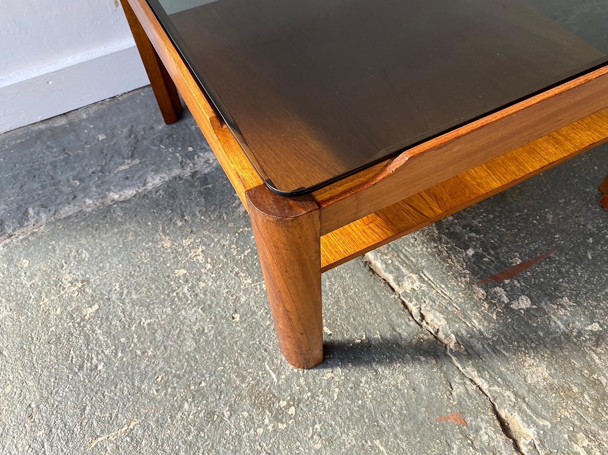 Mid century modern coffee table by respected English maker ‘Myer’. Solid countered teak frame with thick smoked glass insert

Size 
Width 112cm x depth 48cm x height 35cm

Condition:
Very good mid century condition. Minor signs of wear consistent