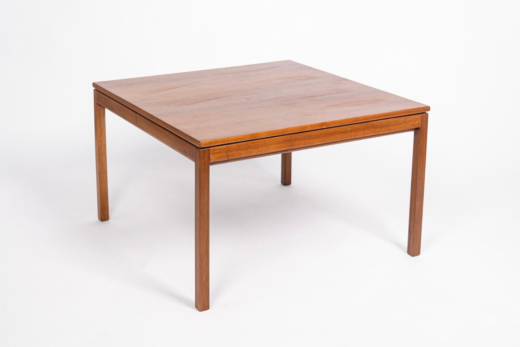 This vintage mid century modern Jens Risom square wood coffee table circa 1960 has a classic Danish modern design with clean, minimalist, geometric lines. The coffee table is solid, heavy and well-crafted from solid walnut with distinctive design