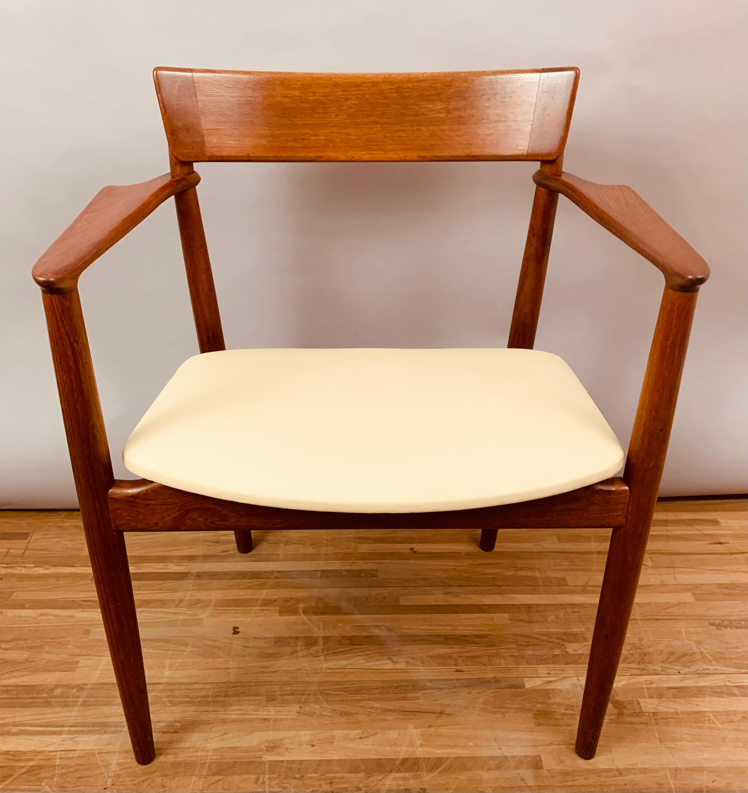 A very well-made and beautifully formed carver armchair with sculpted arms and backrest. Designed in Denmark by designer Henry Rosengren Hansen for Brande Mobelfabrik during the 1960s. Made from solid Teak and newly reupholstered in an off-white