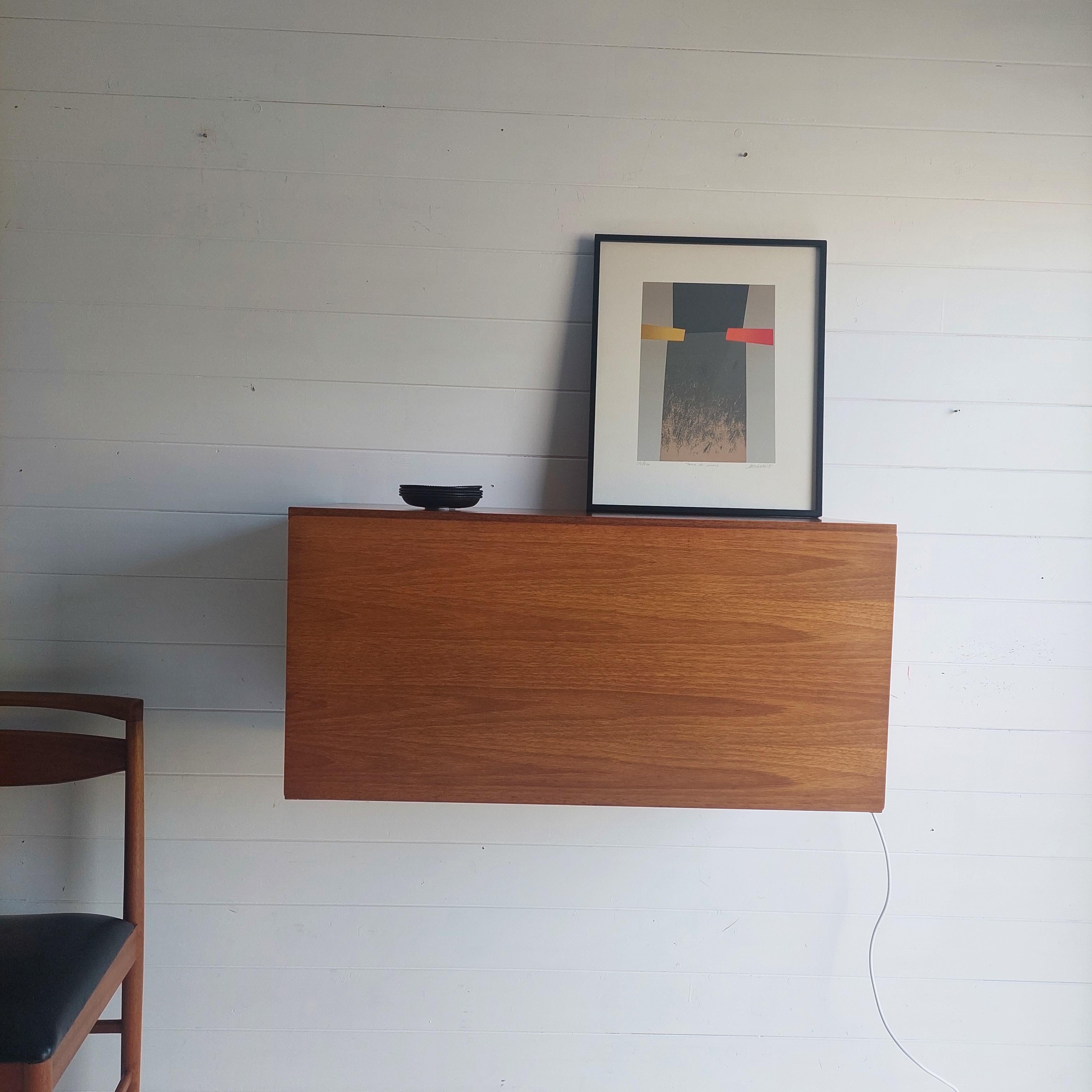 A Beaver & Tapley illuminated floating wall mounted desk storage unit, from their ’33’ range. 
Beaver & Tapley pioneered wall fixed floating units that did away with supporting frameworks. 
Designed by the world renowned Robert Heritage.
Very