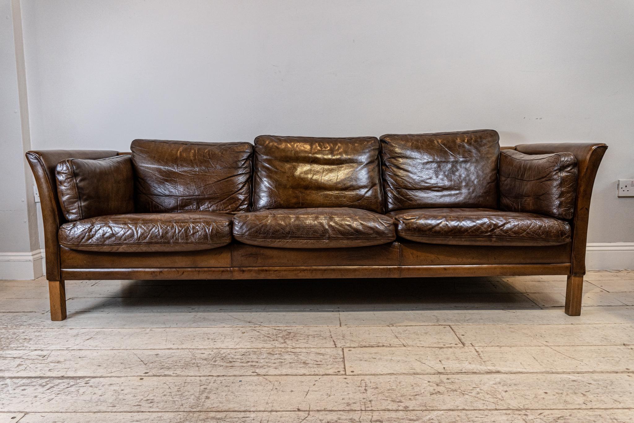 A well sized Mid-Century Modern 1960s Børge Mogensen leather three seater sofa or couch. The leather is of a very good quality with a rich dark brown patina. The legs are made from Walnut. 

This large Scandinavian Classic designed sofa would add