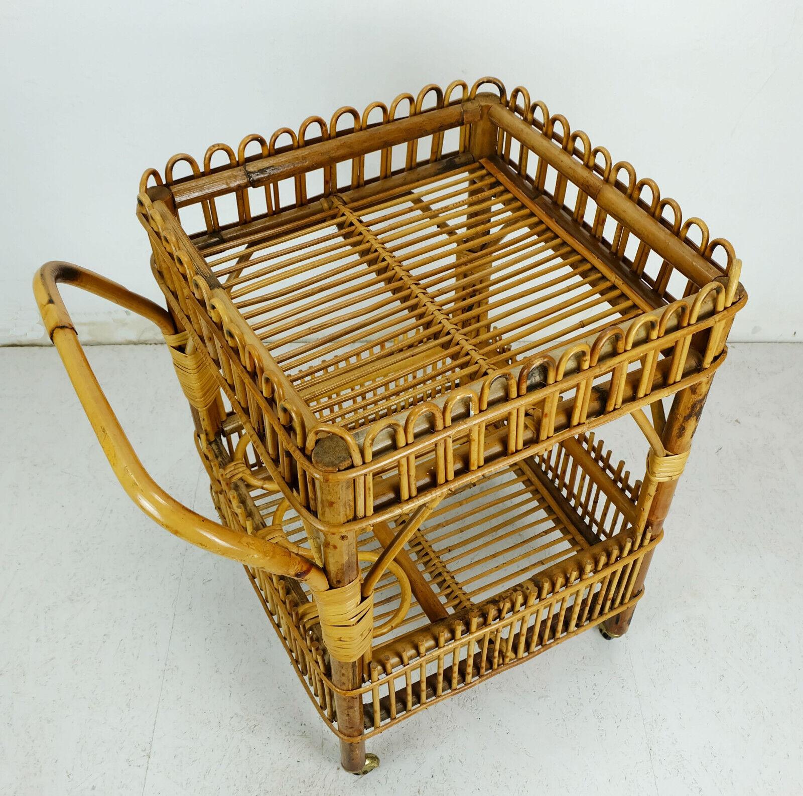 Very beautiful and decorative 1960s tea cart/serving trolley. Made of bamboo and wicker, black plastic wheels with brass covers. Holder for 3 bottles.

Pre-used, very good vintage condition, no damages, just some wear and signs of age on the brass