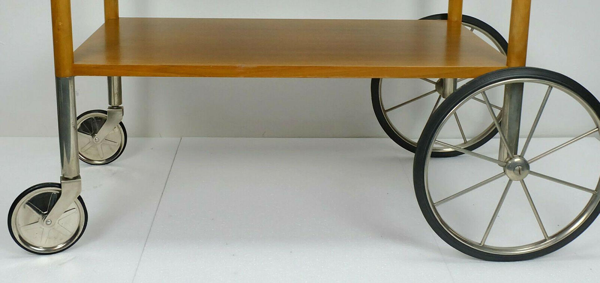Rare 1960s tea cart manufactured by Wilhelm Renz Furniture Company. Outstanding design with 2 large and 2 small wheels. Made of walnut (solid and veneer) and nickel plated metal. The wheels are made of metal and rubber.

Pre-used, good vintage
