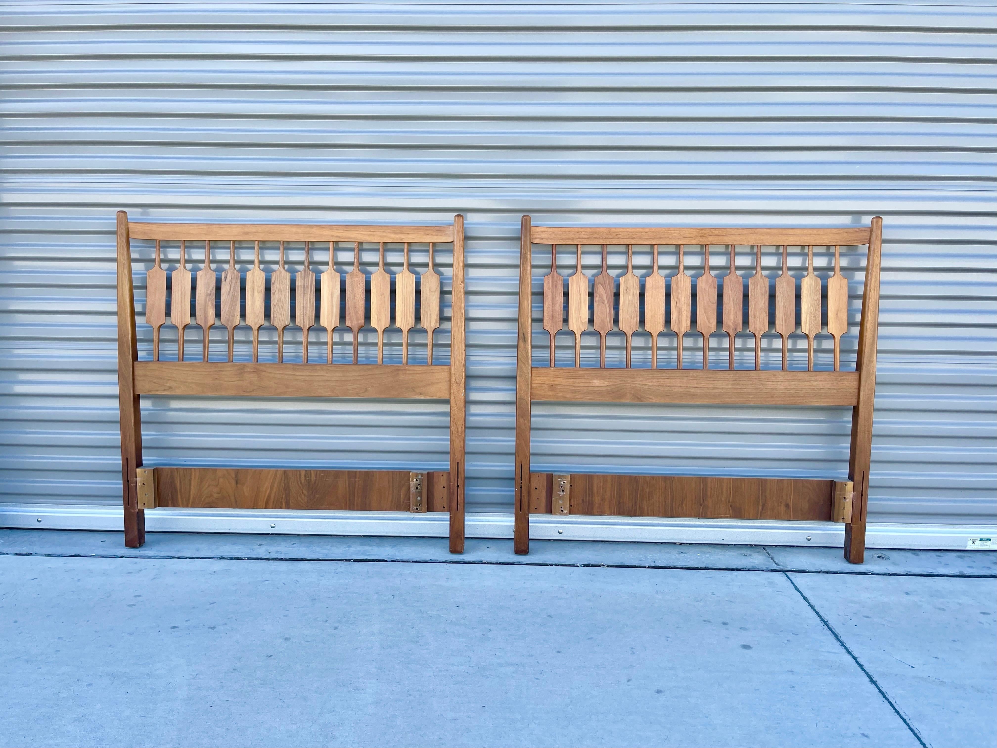 Beautiful midcentury walnut twin headboard designed by Kipp Stweart and manufactured for Drexel in the United States circa 1950s. This wonderful headboard features a walnut frame. The frame works as a twin-size headboard, but you can connect them to