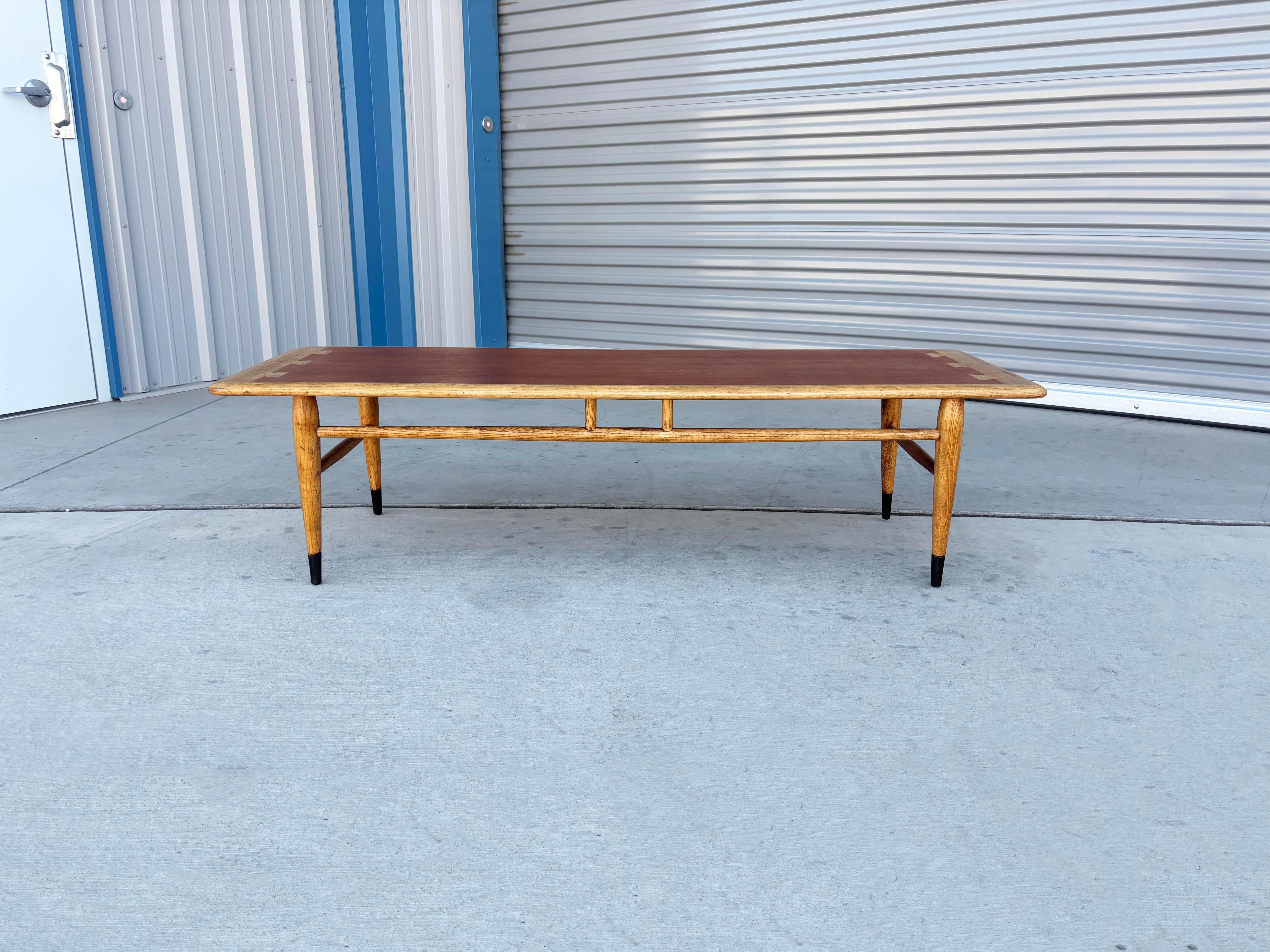 ✨ Mid-Century Walnut & Oak Coffee Table by Lane ✨

This stunning mid-century coffee table, designed and manufactured by Lane in the United States during the 1960s, is a true showcase of craftsmanship and style. The rectangular top features Lane’s