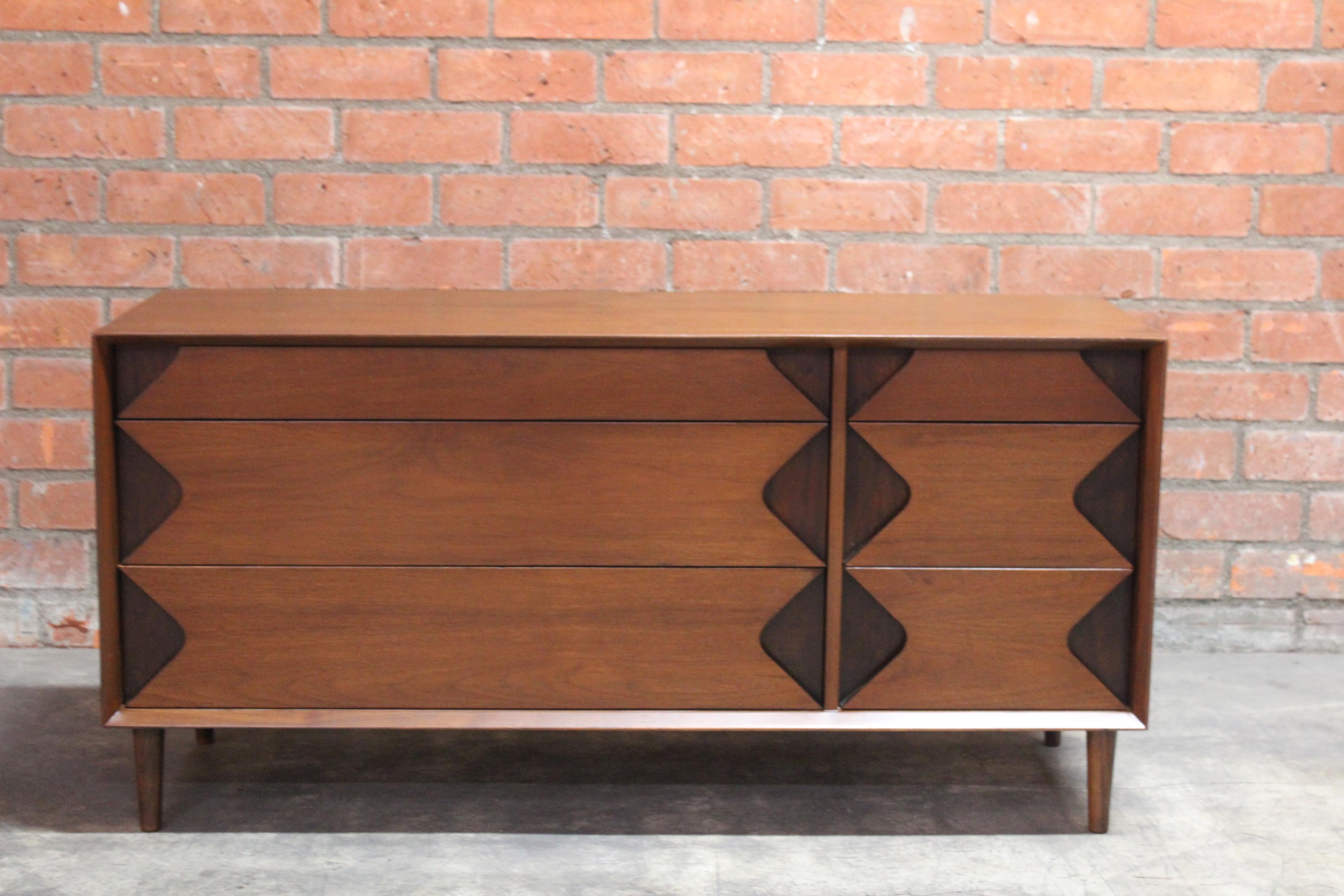 Vintage 1960s walnut dresser designed by Marc Berge for Grosfeld House. Features six drawers. It has been recently refinished and is in overall good condition. There are a few small areas where the walnut veneer was repaired on top, please see