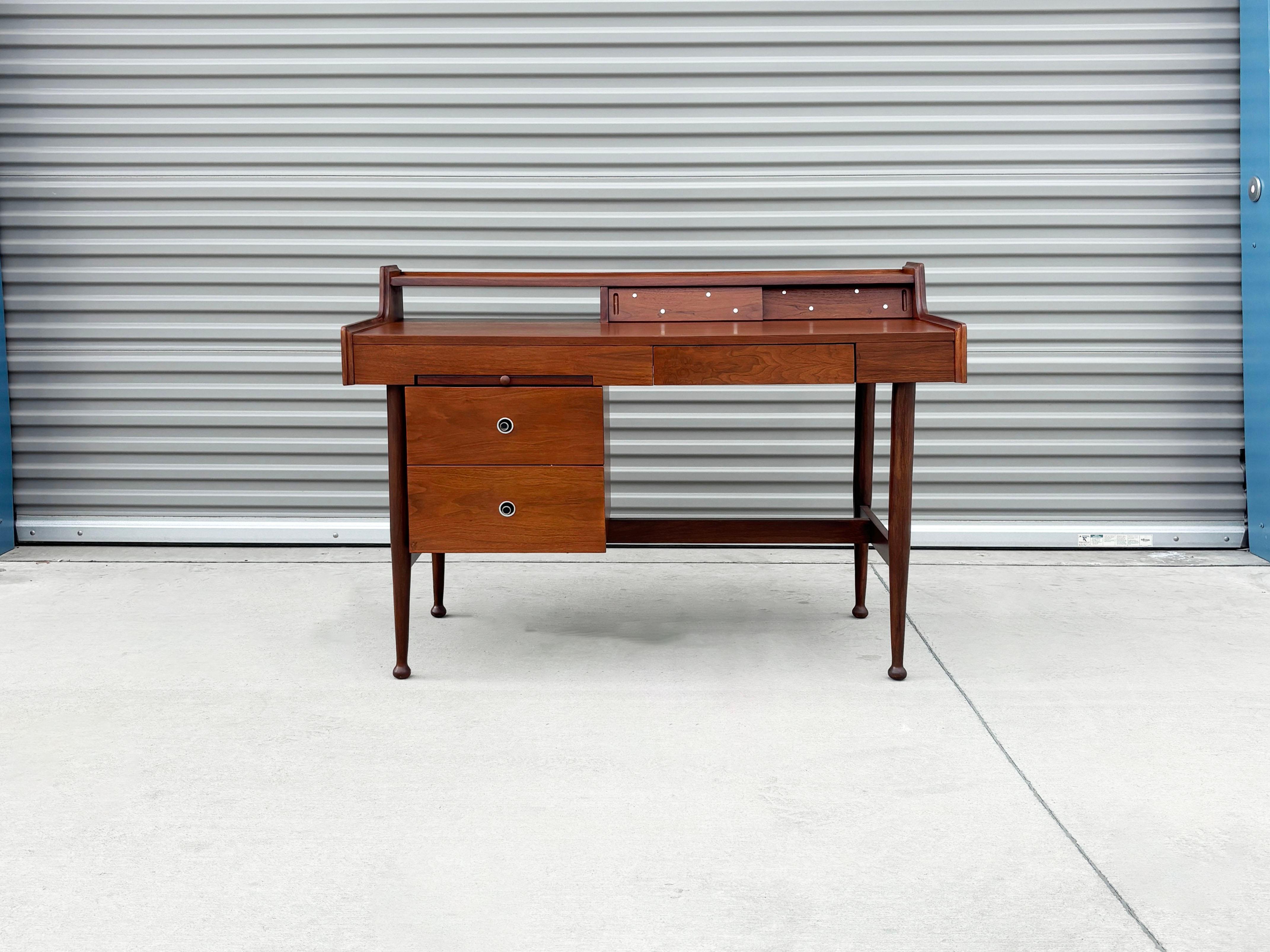 Discover the elegance of this Mid-Century Desk, expertly designed by Hooker for the iconic 