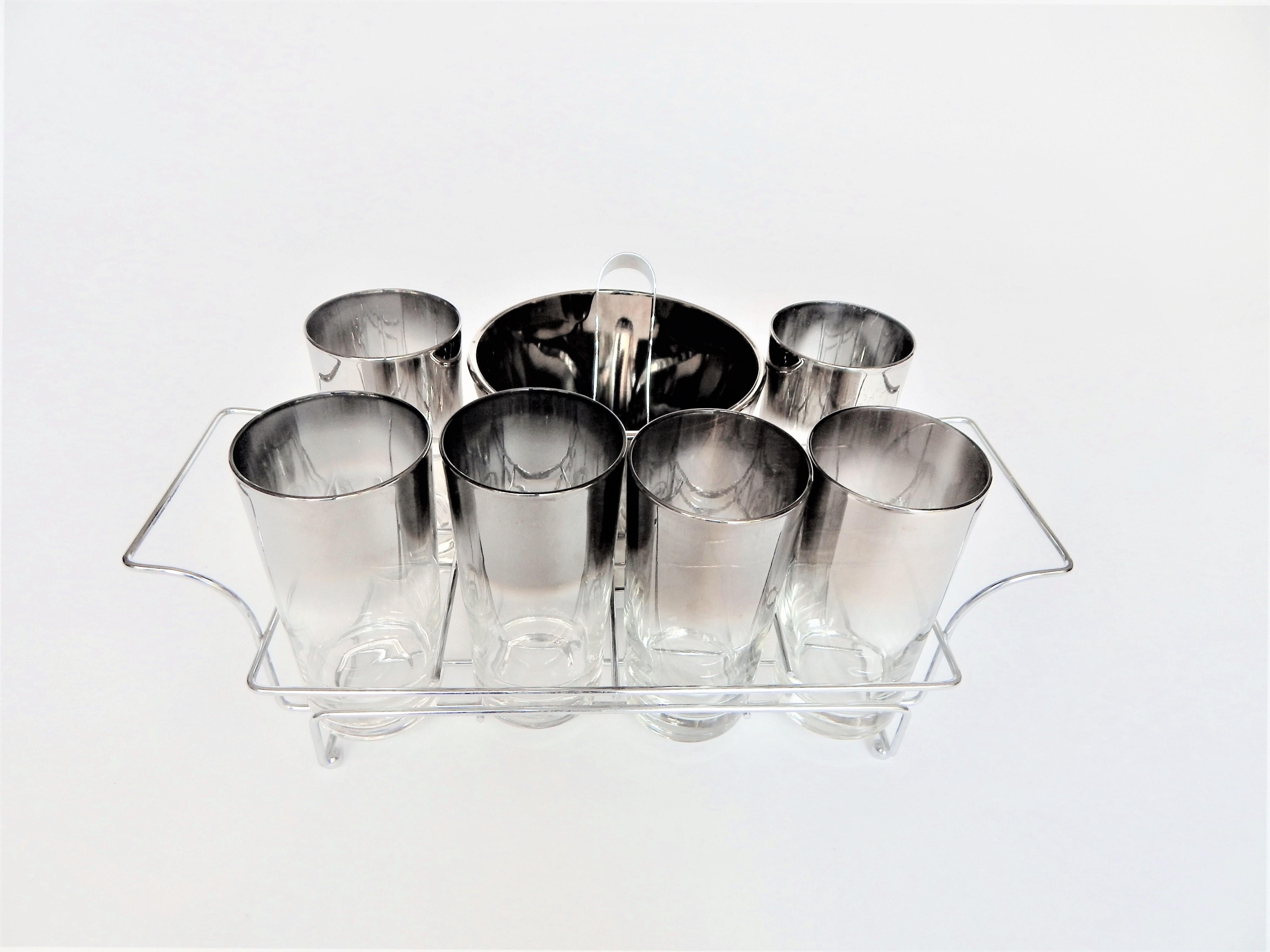 Complete 9 piece set of Dorothy Thorpe 1960s Mid Century Silver Fade glassware / barware set. A perfect addition to any home bar or bar cart. 
Excellent Condition. 
6 glasses
1 ice bucket
1 ice tong utensil
I chrome carrier.
  