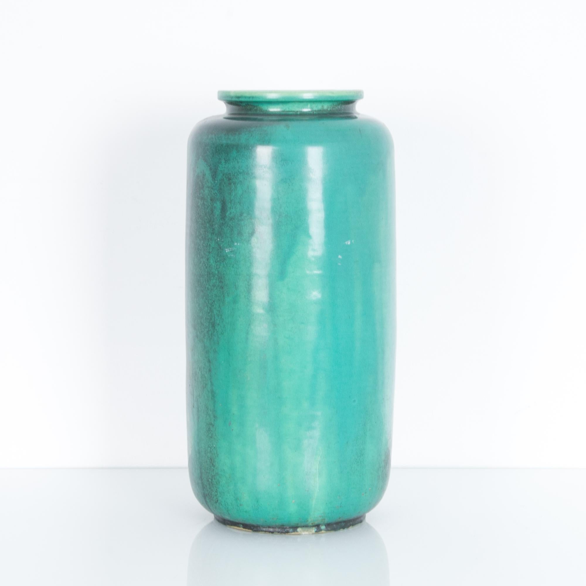 A bold minimal shape, with delicately formed rim. This circa 1960s German vase is glazed with a bright green blue. These characteristic mid-20th century ceramics were produced in West Germany, featuring “W. Germany