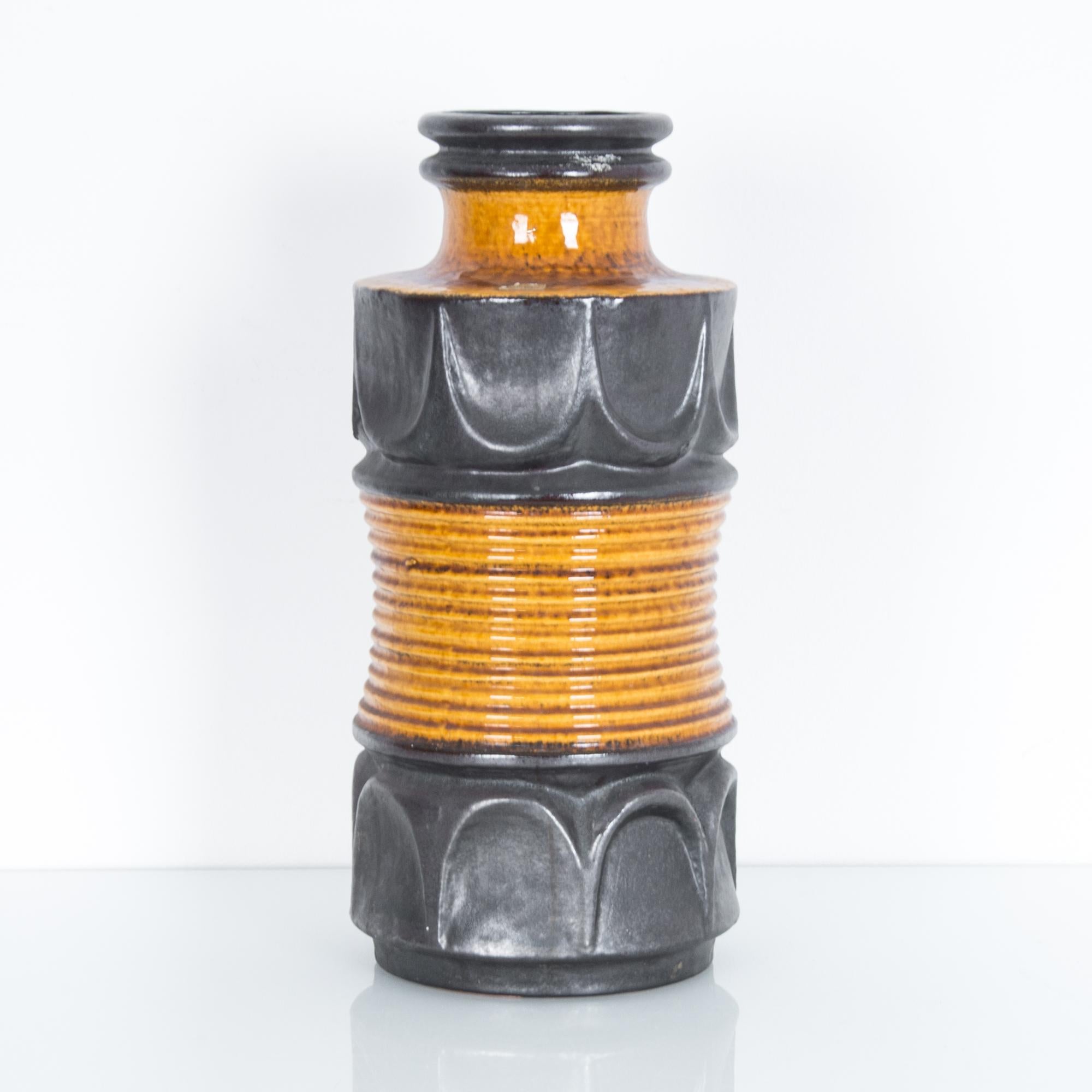 A graphic patterned vase from Germany circa 1960, glazed in metallic grey and orange. These characteristic mid-20th century ceramics were produced in West Germany, featuring “W. Germany