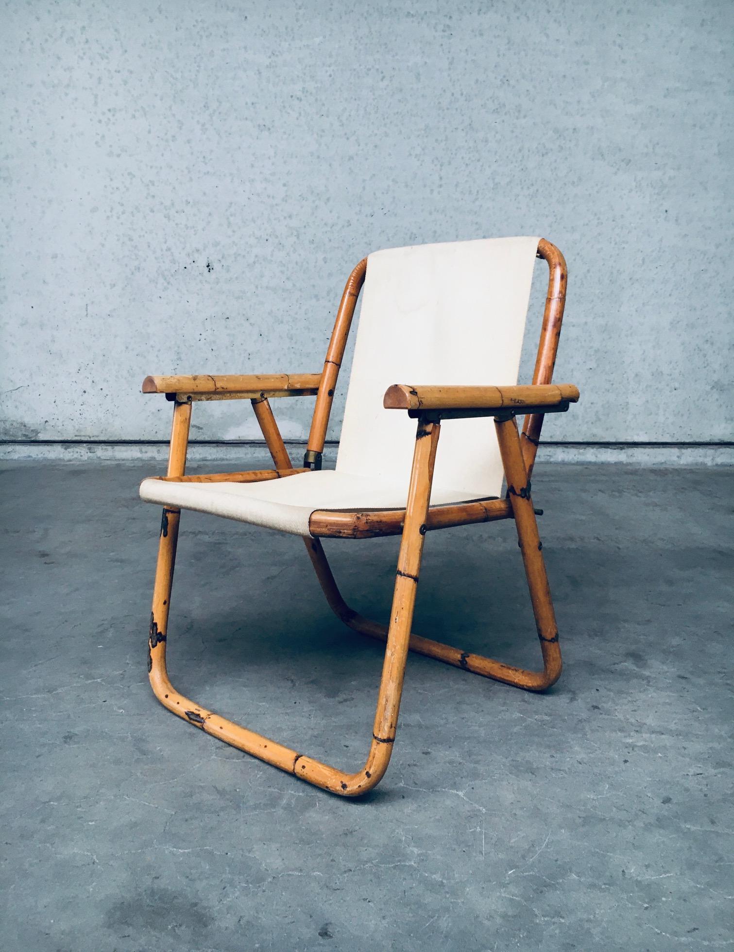 Vintage Mid-Century Modern Italian design bamboo folding chair, made in Italy in the 1960's. Bamboo bent frame with beige cotton seat. Some slight staining on the fabric seat. Folds in and out well. In very good original condition. Measures 64cm x