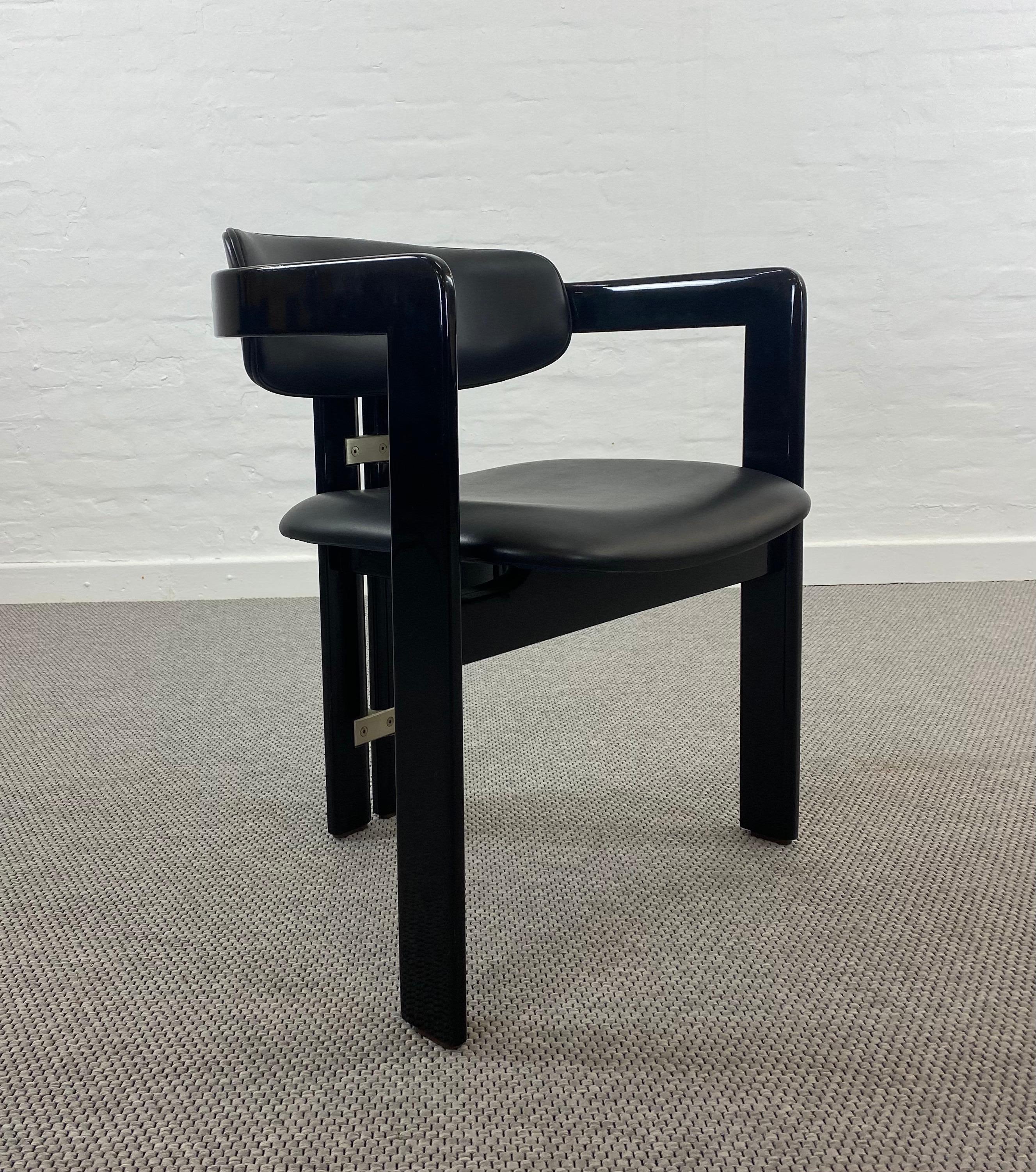 A 1960s pamplona chair from Augusto Savini for Pozzi, Italy.
This is very early and rare example of the Pamplona chair executed in lacquered hardwood and original upholstered in high quality black Leather.

 The chair is a NOS ,new old stock