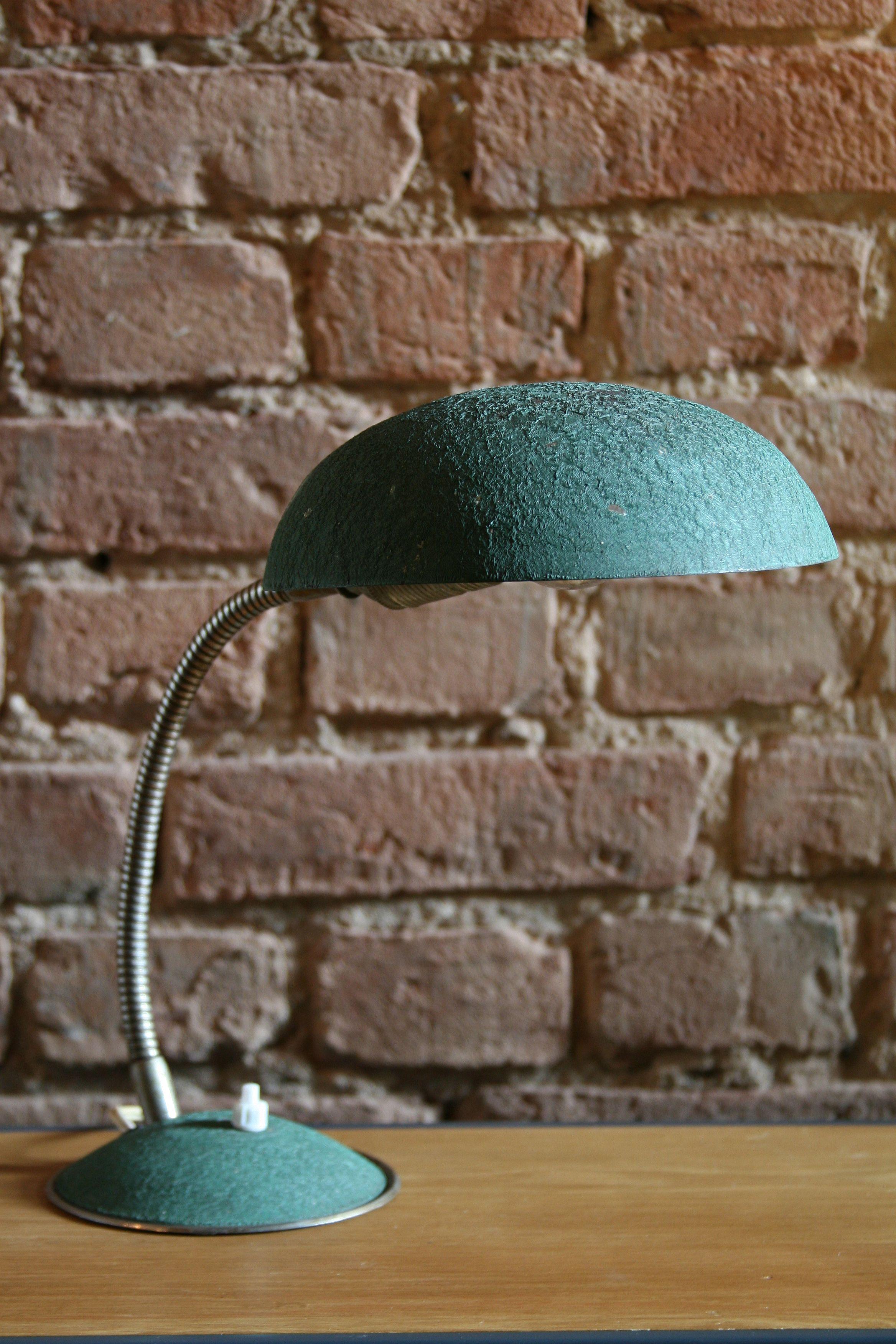 Polish table lamp from the 1960s produced by Warszawska Spóldzielnia Rzemieslnicza (Warsaw Craft Cooperative).

Construction:
Two-part round base is made of profiled sheet. Inside, there is a stabilizing cast iron filling.
In the upper part of the