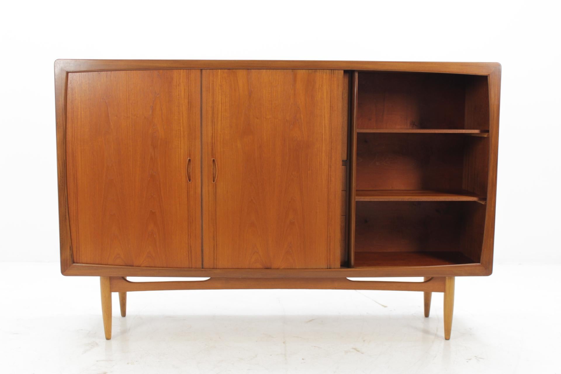 This sideboard features two sliding doors with adjustable shelves and four drawers and one door compartment. This item was carefully restored.