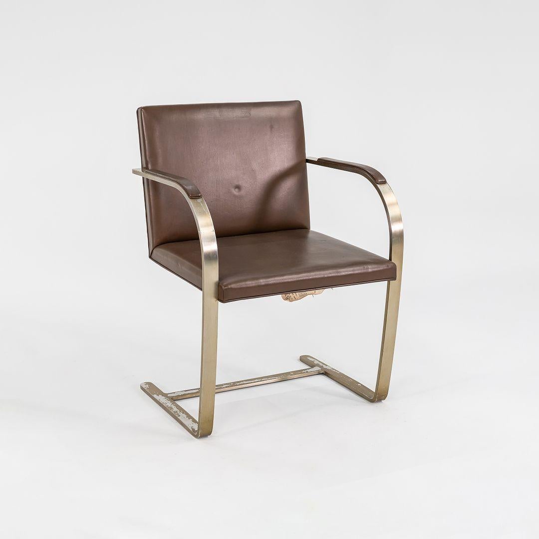 This is a ‚ÄòBrno‚Äô Armchair, model MR50, designed by Ludwig Mies van der Rohe & Lily Reich in 1929. This particular piece was produced by Knoll in the 1960s. The design features a flat bar steel frame that has an antiqued brushed-bronze finish,