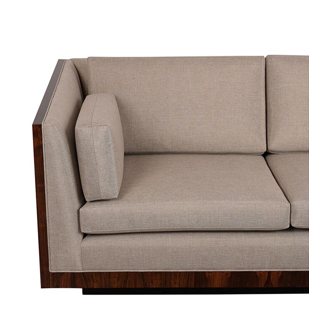 This modern cube rosewood sofa by Milo Baughman is completely restored, has a new lacquered finish, and features a floating base. The sofa has been newly re-upholstered in light grey fabric has three seat cushions, three back pillows, and two throw