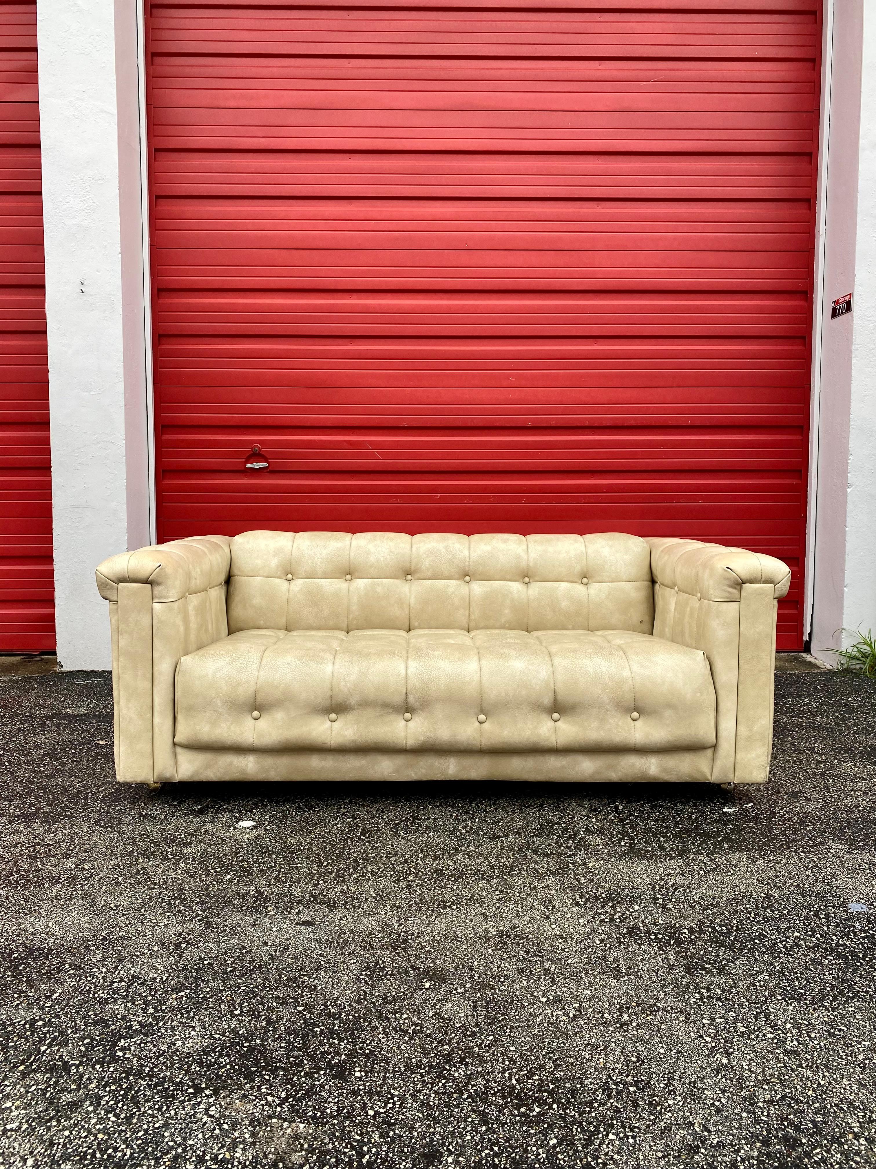 Rare and in original condition. Inherently stylish and intriguing! For your consideration is a sleek and stylish love seat sofa in the style of Milo Baughman, circa 1960s. Elegant from every angle-his best sofa design. Dripping with style makes this
