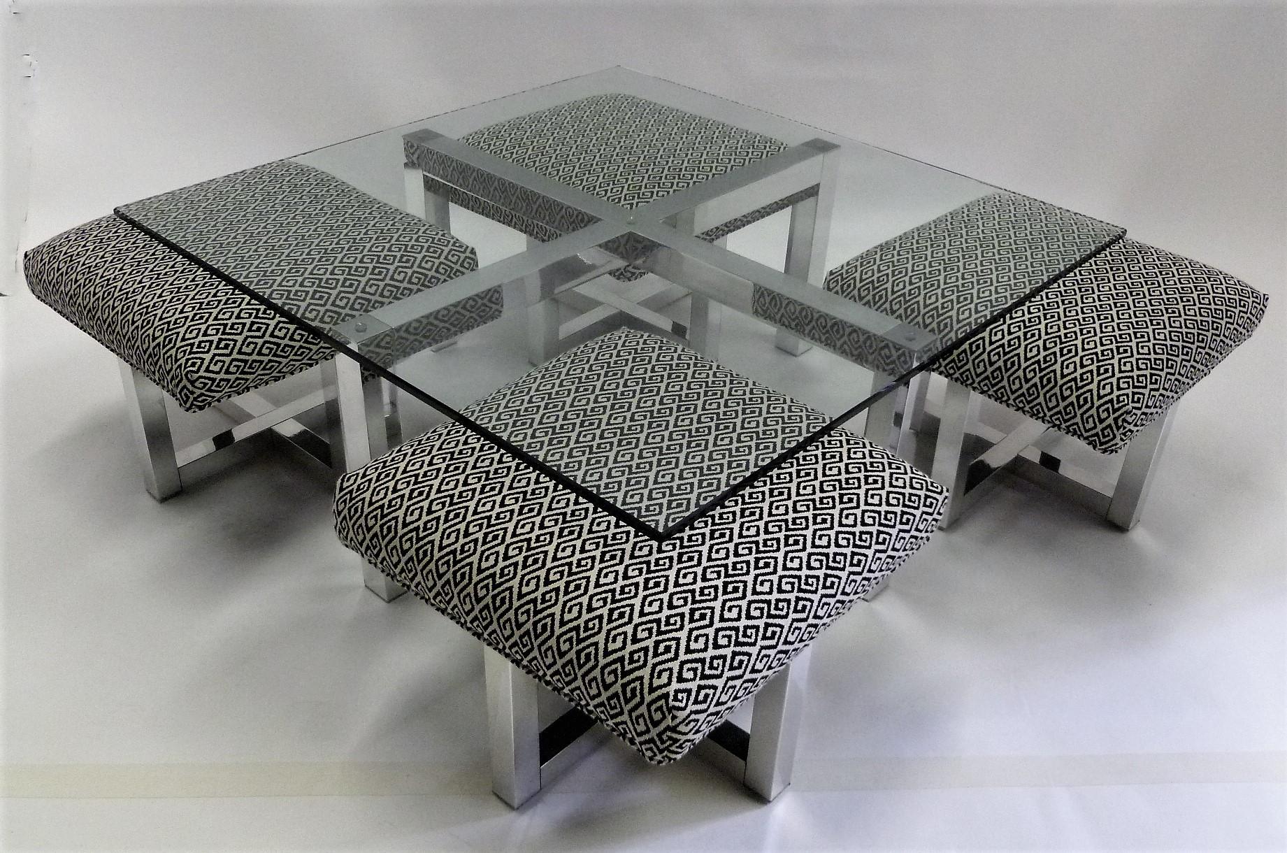 Reduced from $3,800.....Unique 1960s Glass topped polished aluminum coffee table with nesting stools or ottomans in the style of Milo Baughman. The Table with a polished aluminum X-base and new 1/2 inch square glass top, with four stools on polished