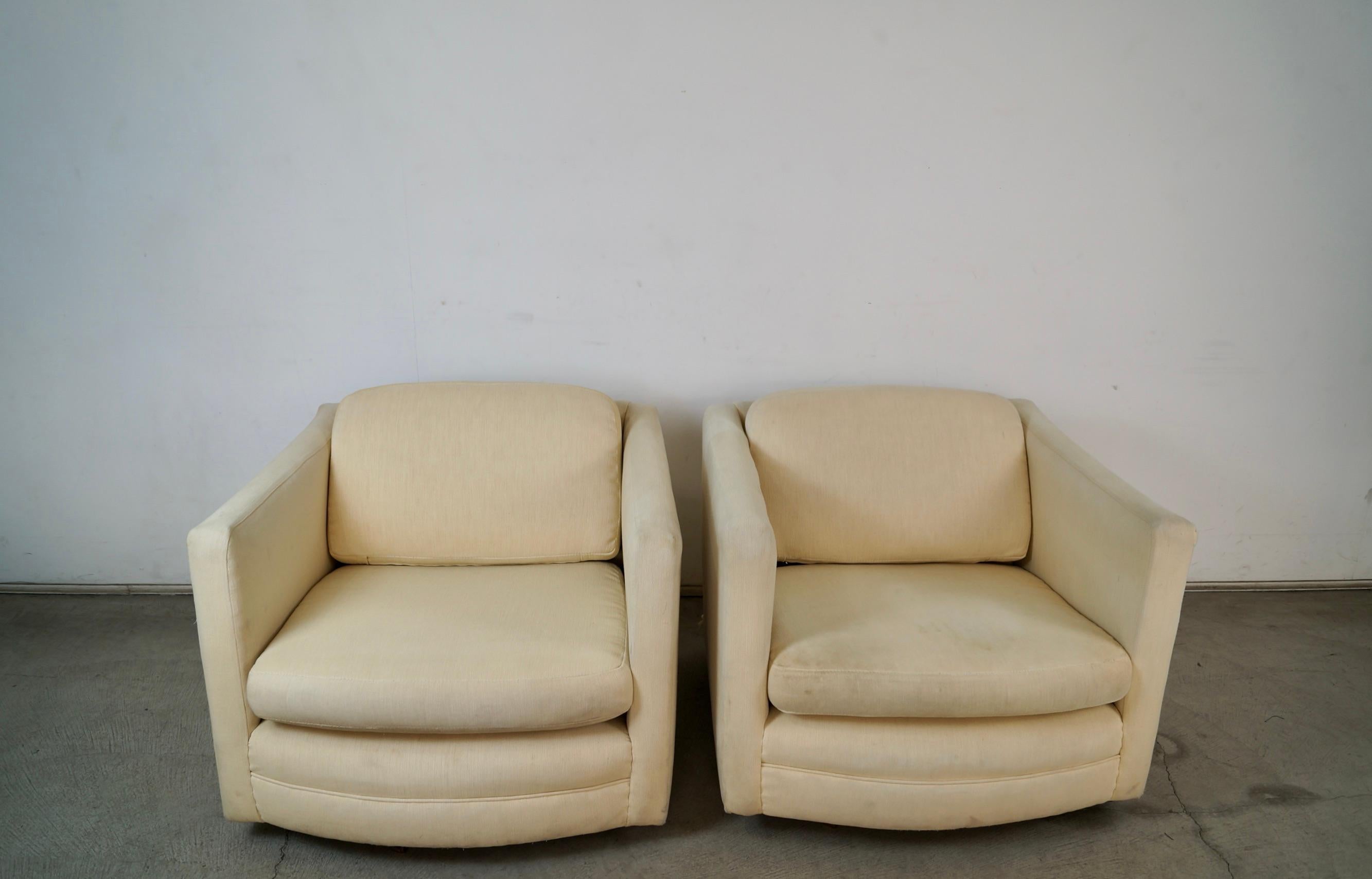 Pair of vintage Mid century Modern club chairs for sale. These are from the late 1960's, and were previously reupholstered in the 1980's in a cream upholstery. The fabric shows vintage wear, and are being offered as an upholstery project. They have