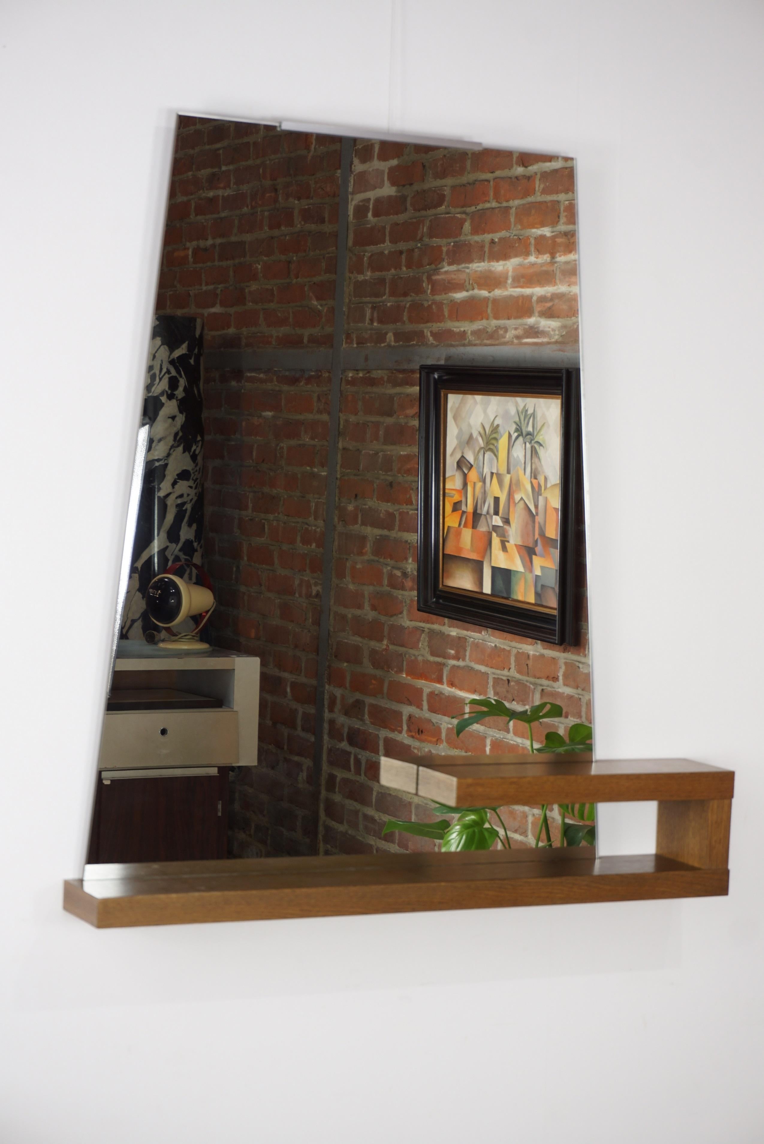 1960s free-form design mirror, with sober, graphic and Minimalist lines on which comes an oak shelf. Robust, elegant, beautifully crafted and in excellent condition. Ideal in the lobby, it will also be perfect in the living room or your bedroom!