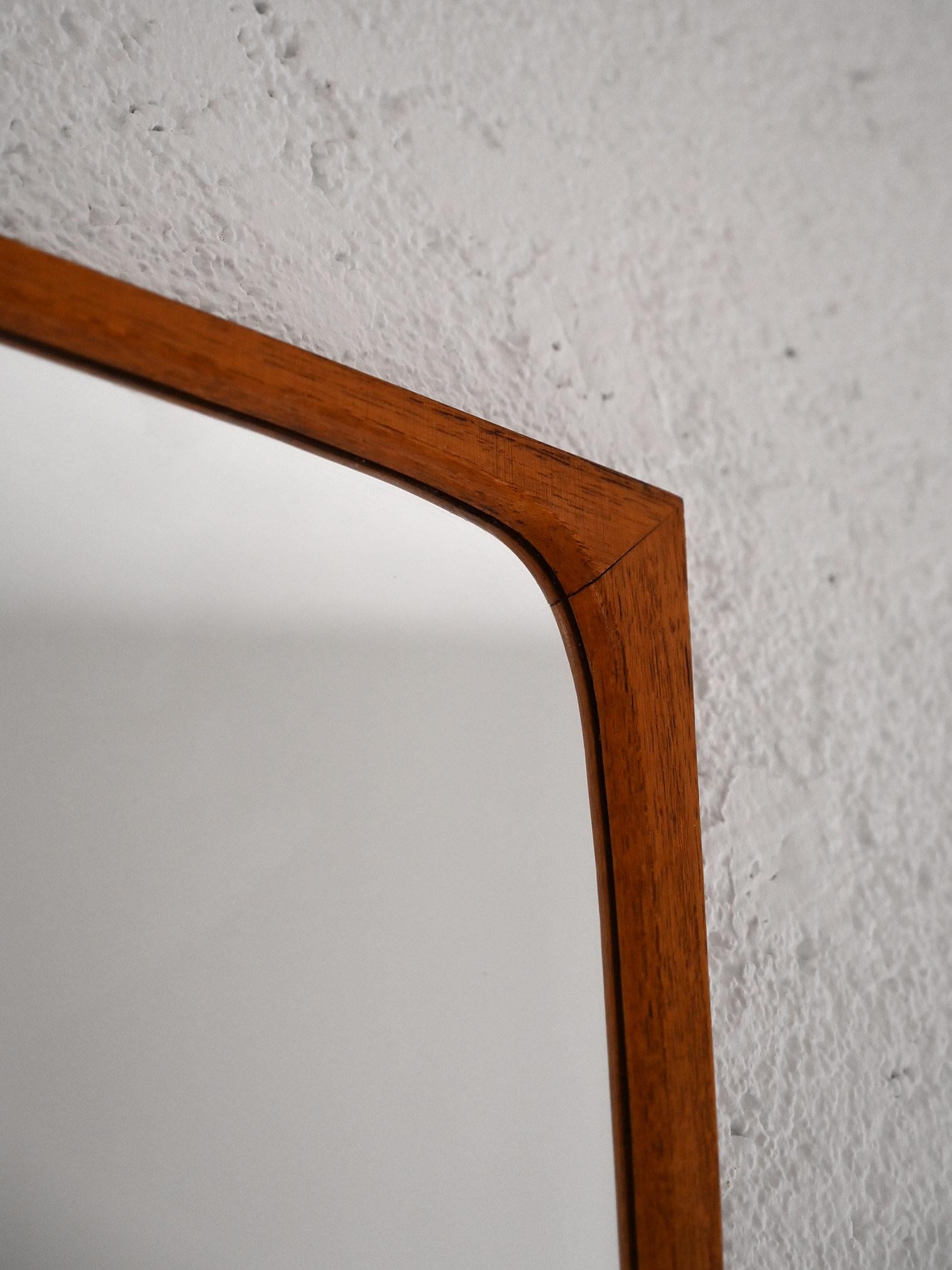 Vintage mirror of Scandinavian origin.

The characteristic feature of this mirror is the shape of the teak frame, which internally has rounded corners while externally is rectangular. The simple lines and attention to detail make it an elegant and