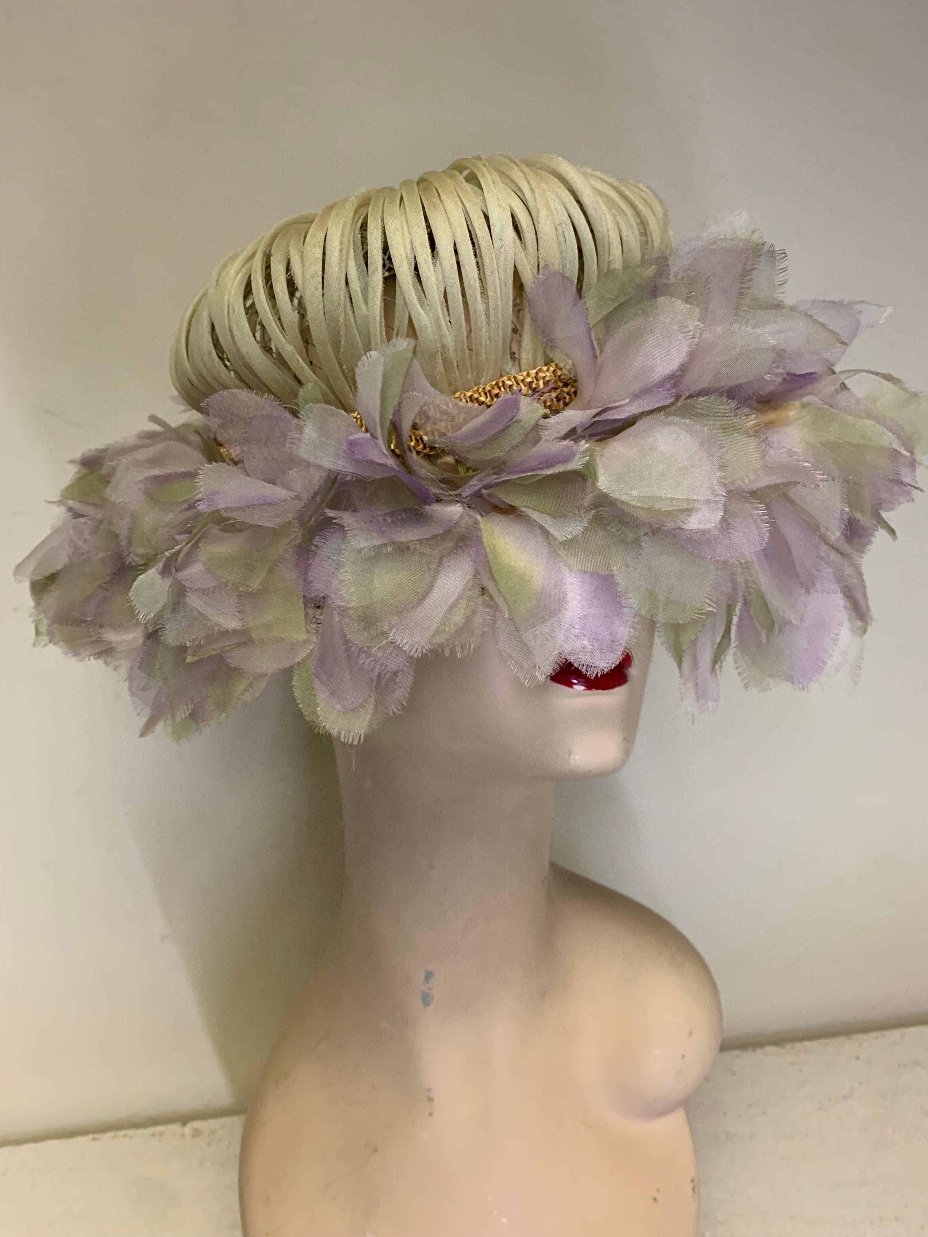 A charming 1960s Miss Alice floral petal brimmed Mod style hat: the brim is made of cool-toned lavender petals and the crown is covered in pale green silk stems. It's banded with a braided straw rope. Originally sold at Lord & Taylor. One size. 