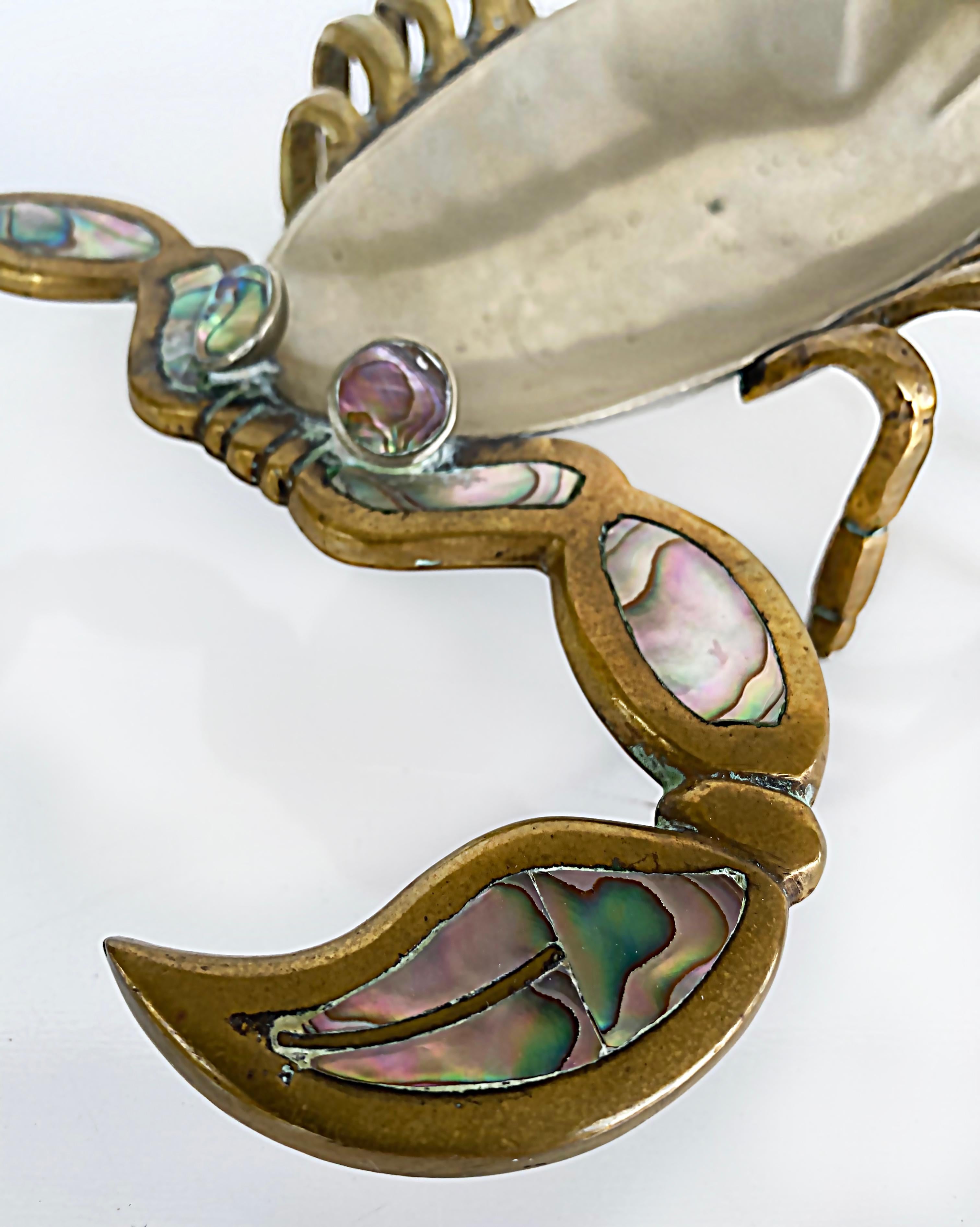 1960s mixed metals/Abalone Scorpion Tray, Los Castillo Style, Mexican

Offered for sale is a Mexican Mid-Century Modern mixed metals tray with abalone that has been created in the style of Los Castillo. The scorpion is made from brass and copper