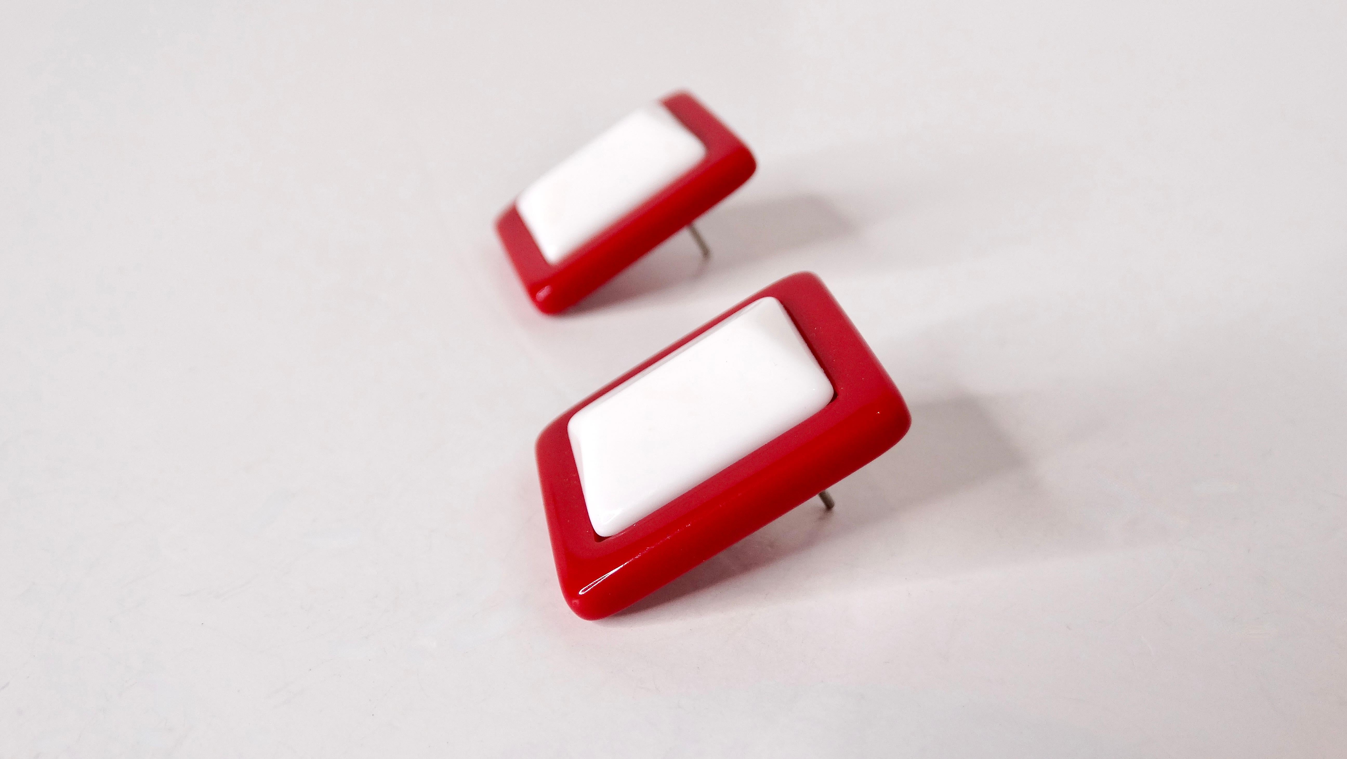 Step back into the vibrant 1960s with these striking Mod Red & White Geometric Contrast Earrings, a quintessential piece of mid-century fashion. Crafted from lightweight plastic, these vintage earrings marry playful design with bold color contrasts,