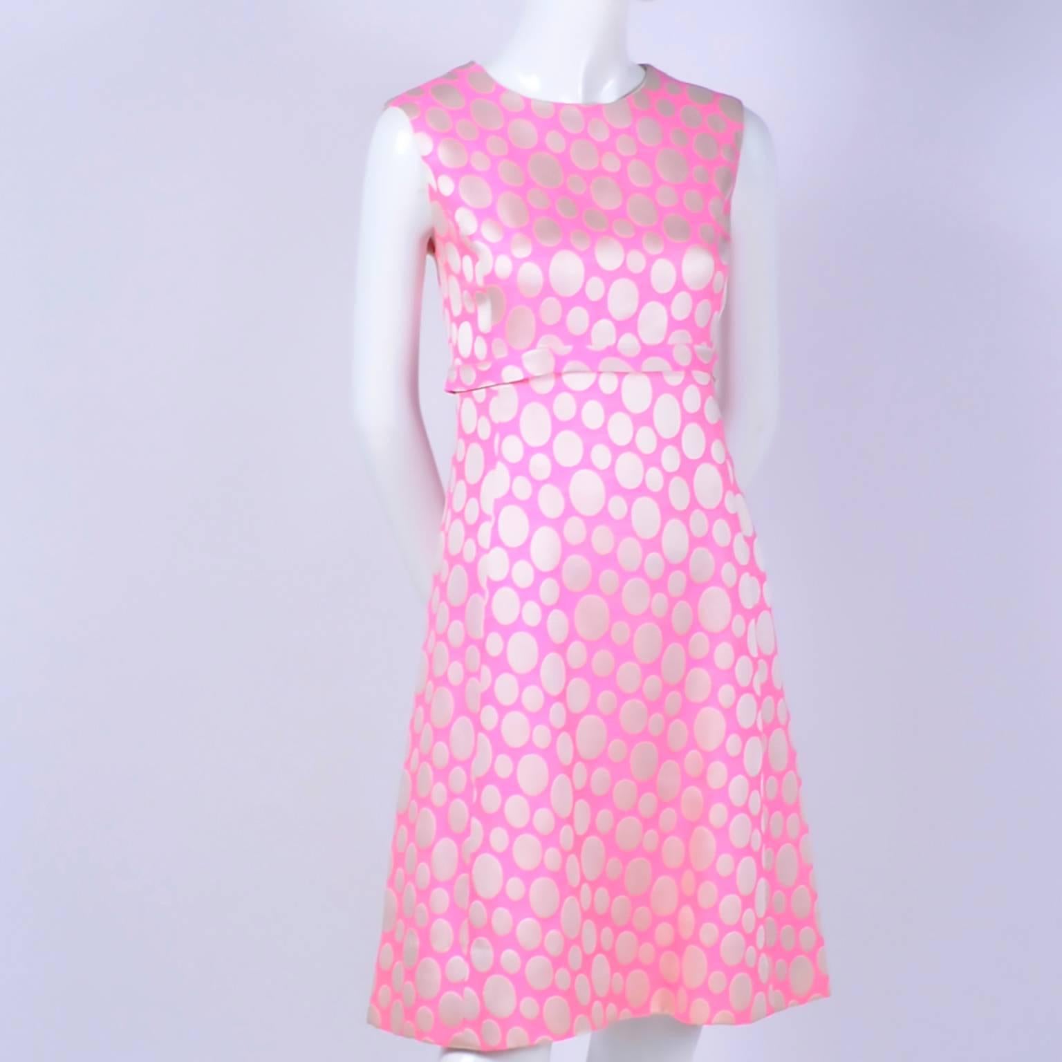 This pink and ivory polka dot ensemble includes a sleeveless, empire waist dress and a matching coat.  The suit was purchased in the 1960's at the Crest Room at Meier and Frank Department store. The Crest room was a specialty department of the store