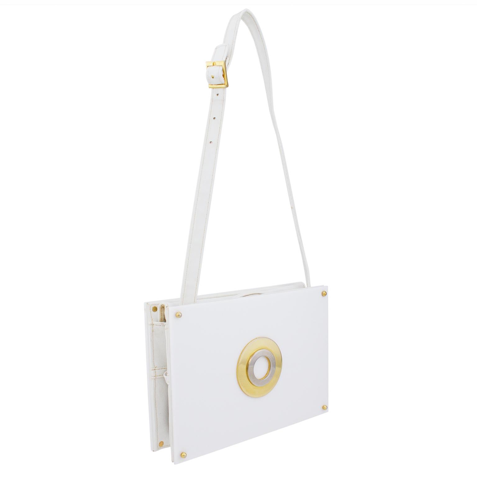 Very fun and ultra mod 1960s Saks Fifth Avenue bag. White hard plastic with adjustable and removable white leather strap and interior. Circular gold and silver detail on front and gold hardware throughout. Very good vintage condition, normal signs