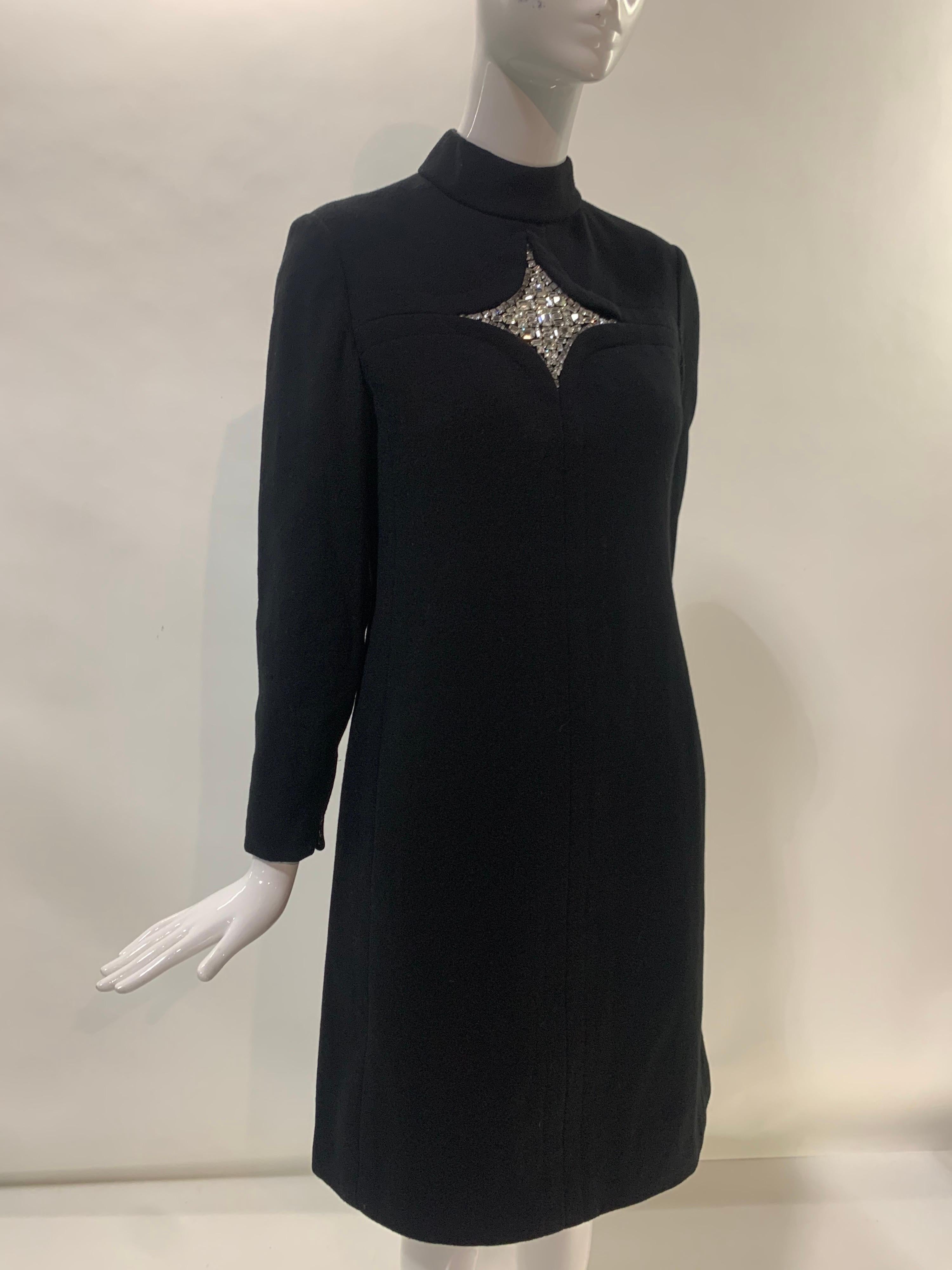 A fantastic 1960s Mod black wool crepe tailored dress from I. Magnin. Possibly a Teal Traina, but no maker indicated. Fantastic details are found in this supremely simple yet impossibly chic stunner: At center front bust is a tailored star-shaped