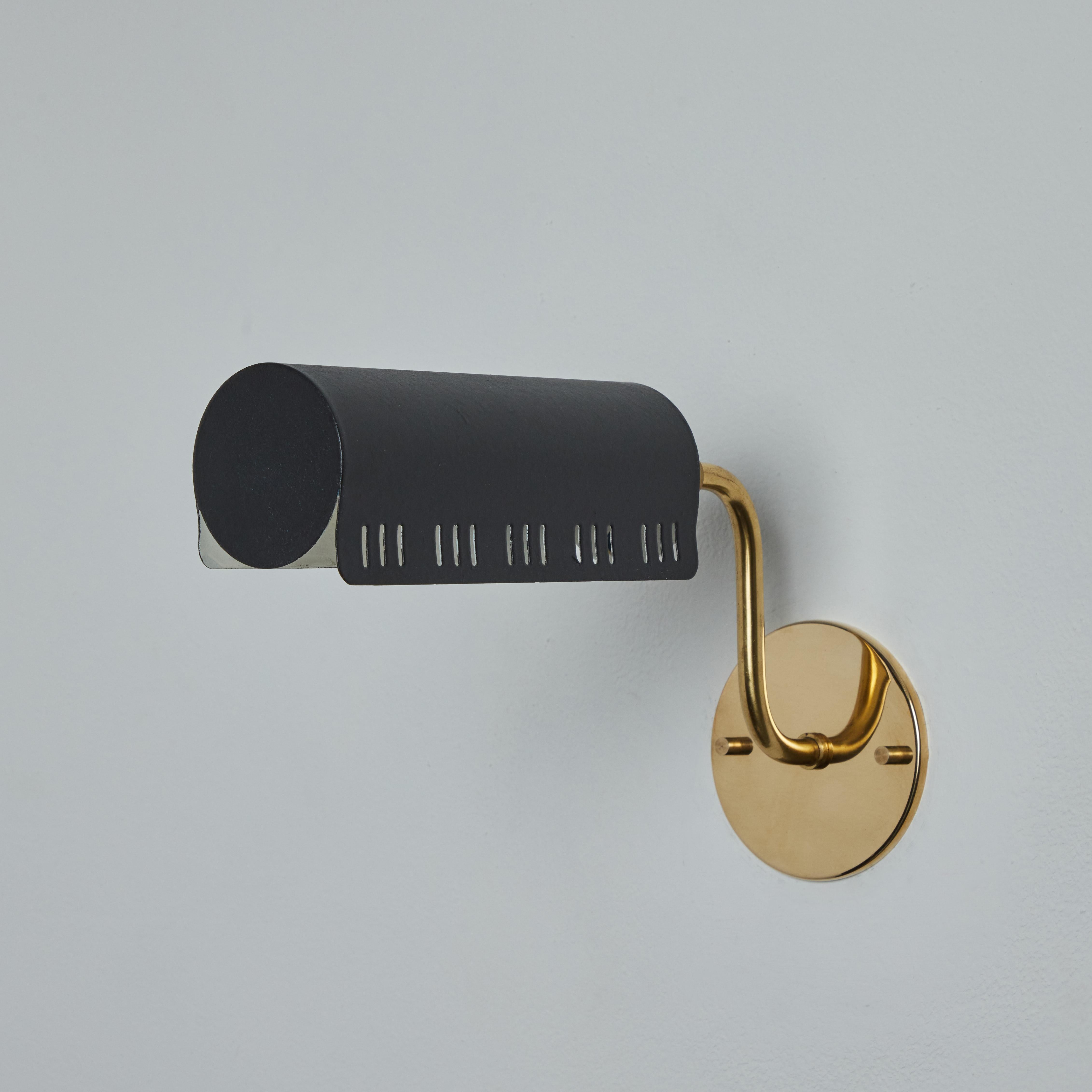 1960s Model #8260 Black Metal and Brass Wall Lamp for Falkenbergs Belysning.

Executed in black painted perforated metal shade with brass hardware, this highly adjustable wall light swivels freely to cast either direct or diffuse indirect light.