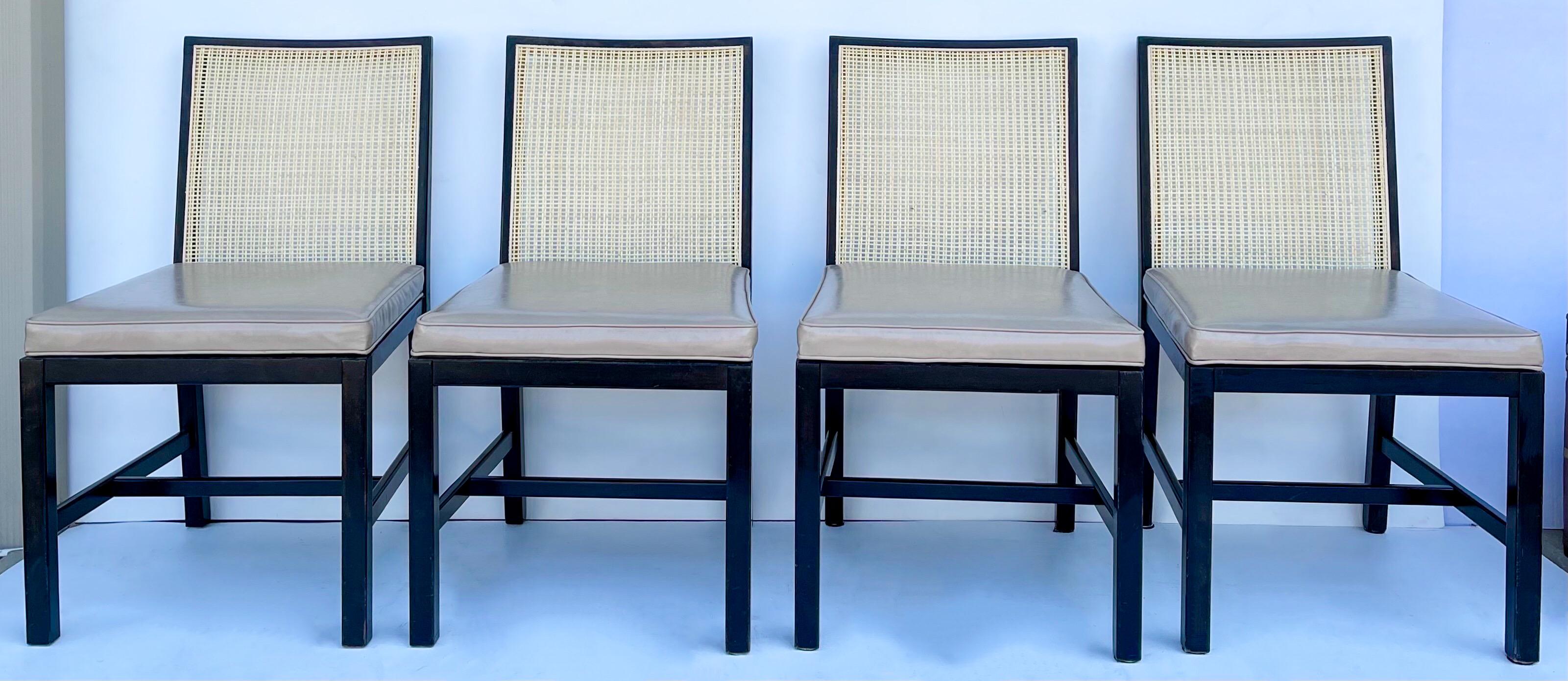 This is a set of eight modern caned Michael Taylor for Baker Furniture side chairs. The caned is natural and has been restored. The beige leather upholstery is vintage and shows light wear. The ebonized frames are in very good condition. Measures:
