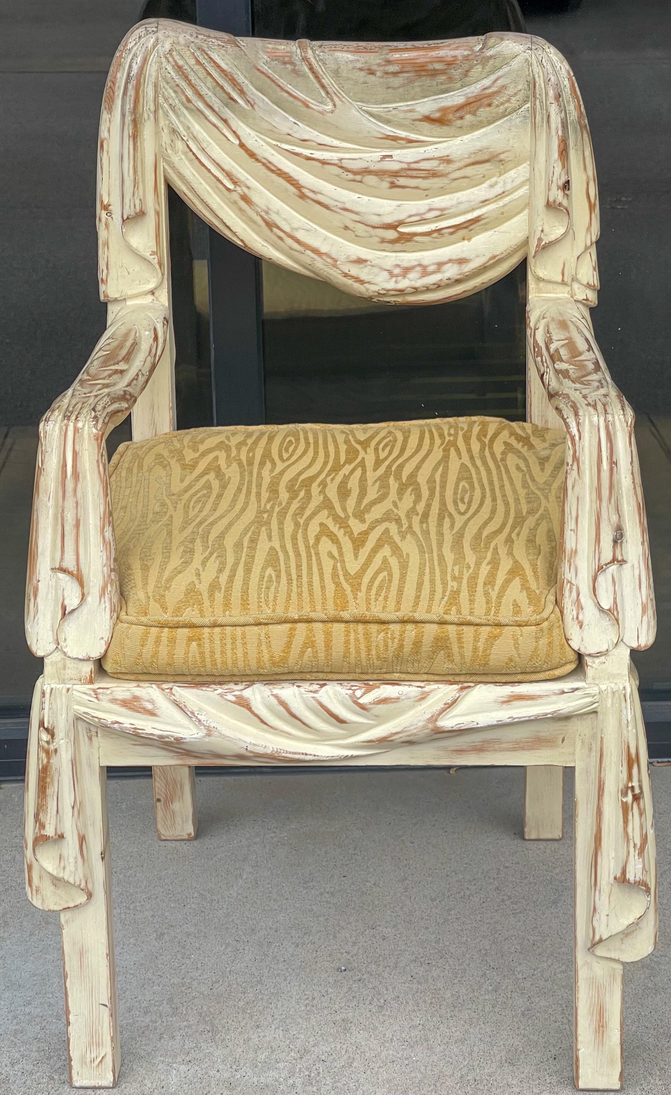 This is a statement piece! This is a carved and cerused arm chair by Chapman and hand crafted in Spain. It has a faux drape and carved form that combines some faux bois elsmsnts. I do have a side chair as well if interested. The upholstery is