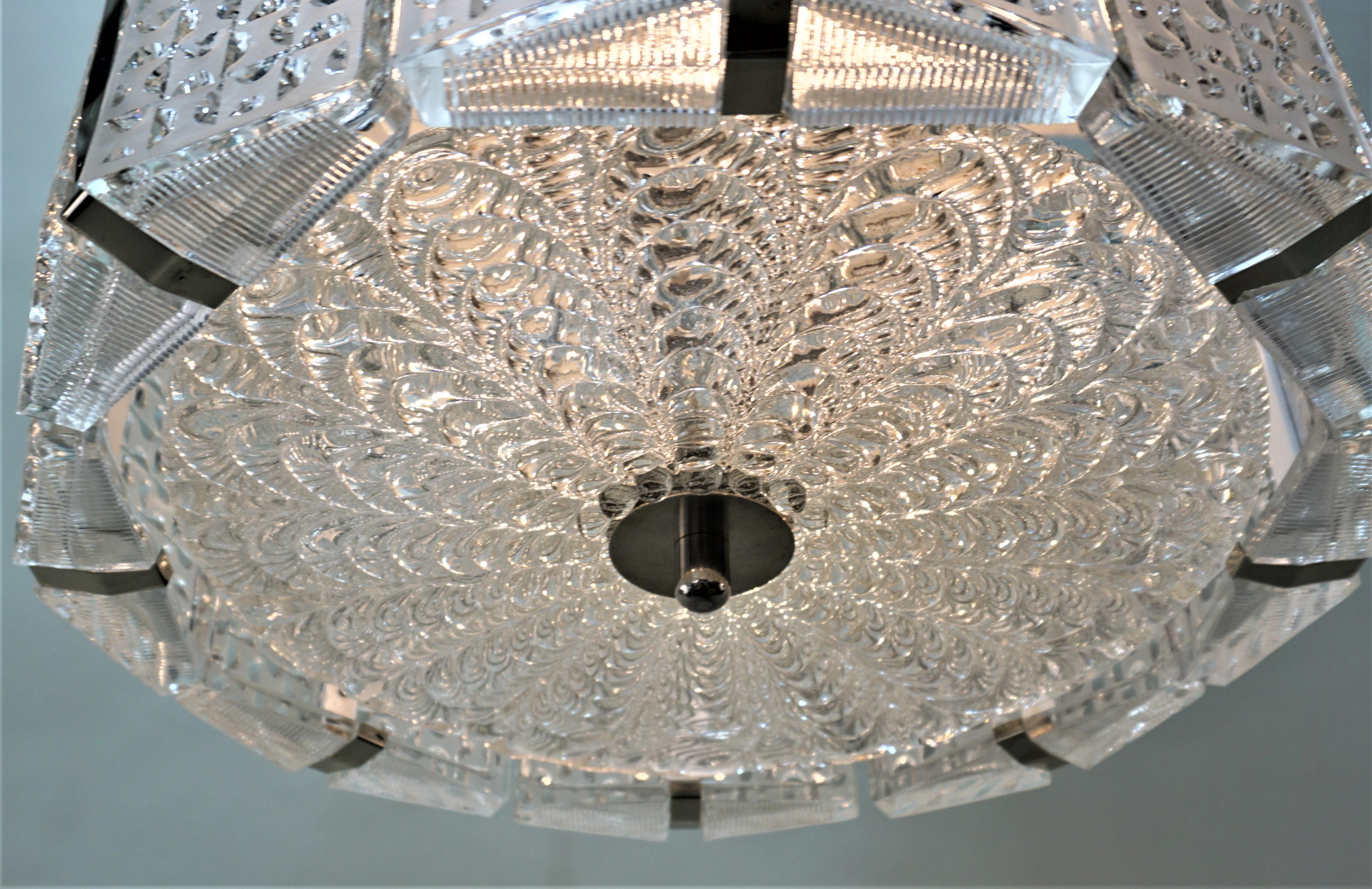 Eight texture clear glass side panels as well as center texture glass with nickel/chrome hardware chandelier.
