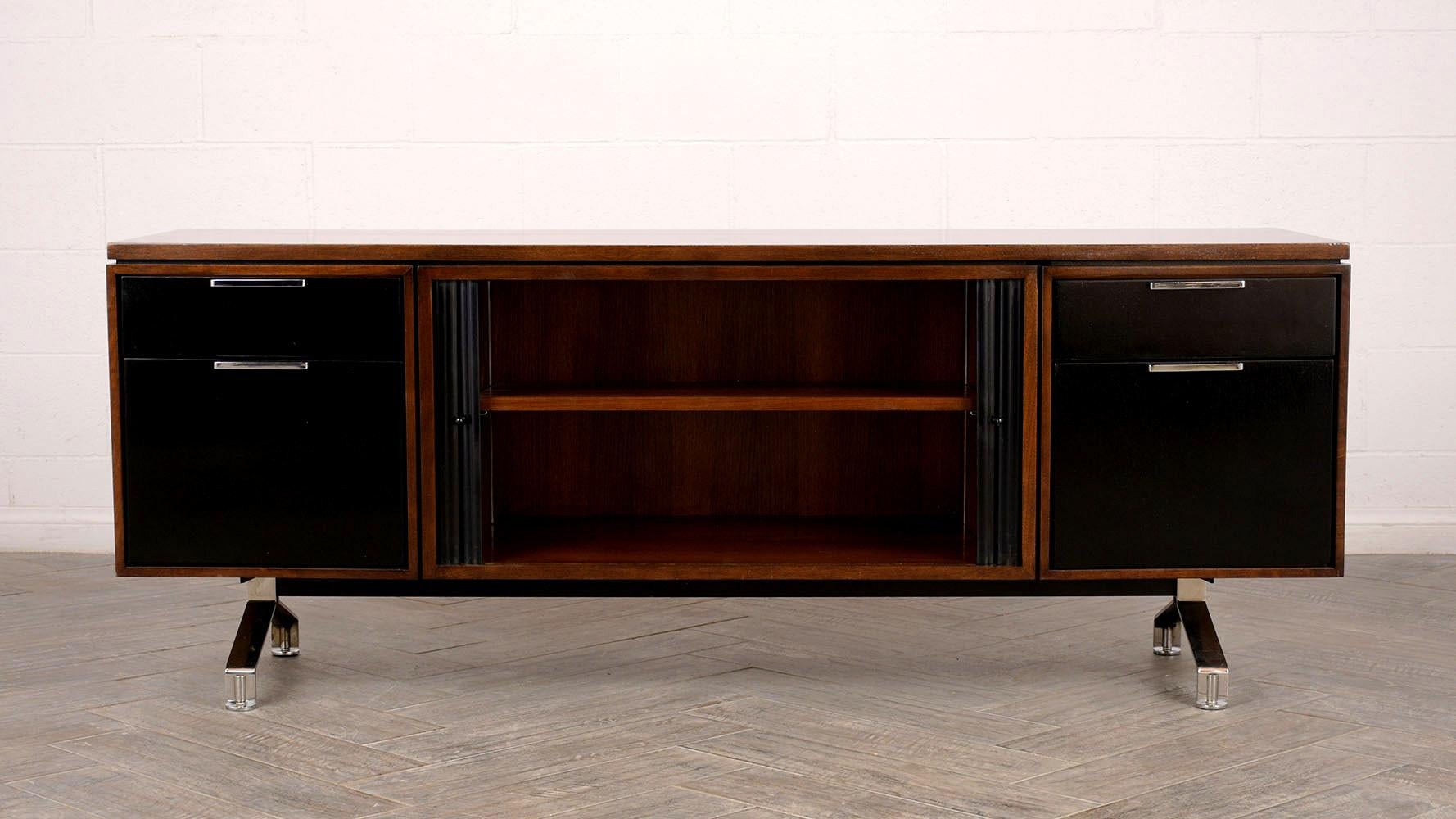 Beautiful Mid-Century Modern walnut credenza, its been stained in a rich walnut and black color combination with lacquer finish. With two sliding tambour doors at the center of the piece, combined with two small top drawers and two deep bottom