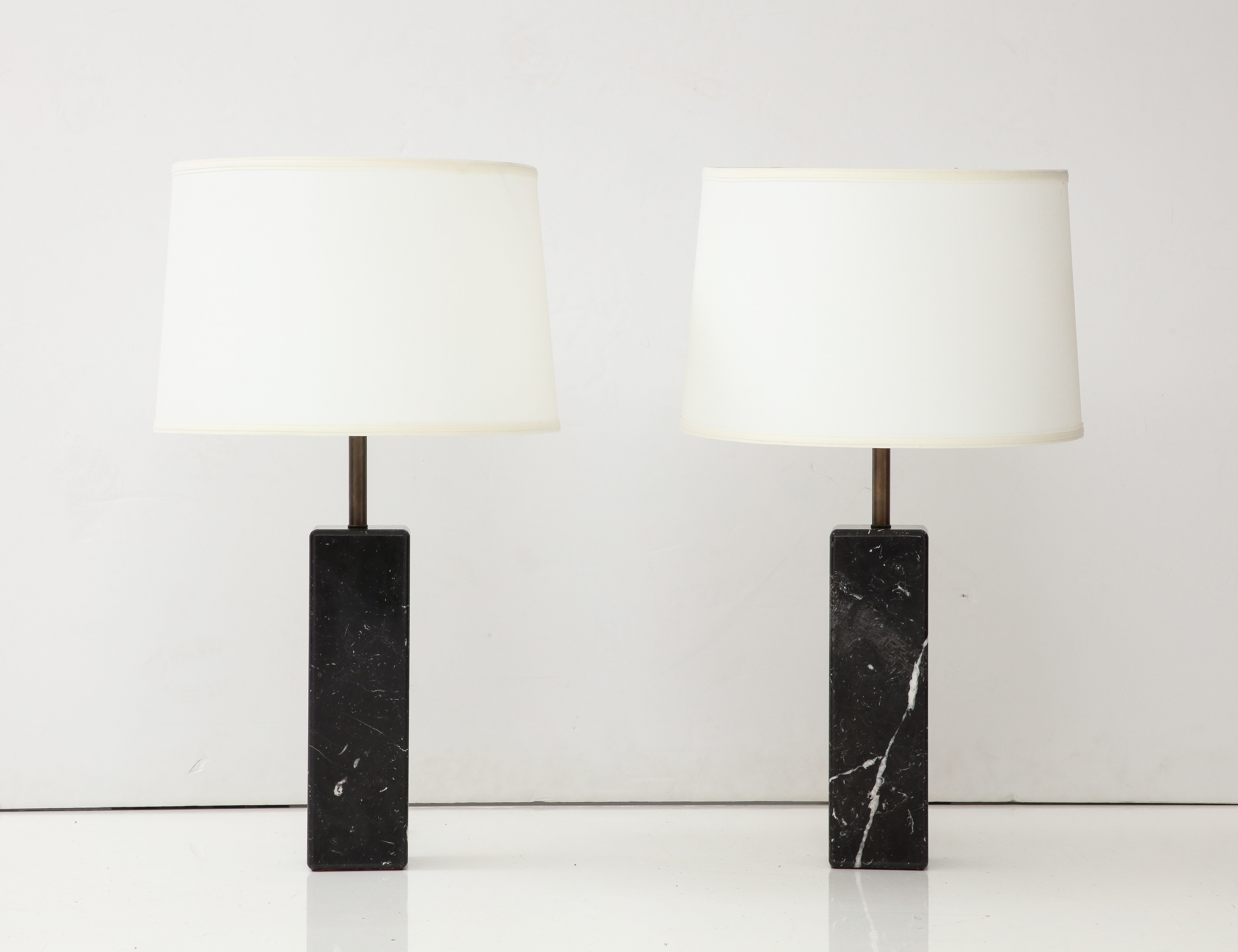 1960's mid-century modern solid Carrara Marble with brass hardware with original glass shades table lamps designed by Walter Von Nessen, in vintage original condition with minor wear and patina due to age and use, newly rewired with brown silk